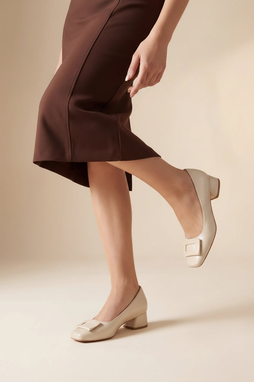 Person wearing white shoes with a neutral background