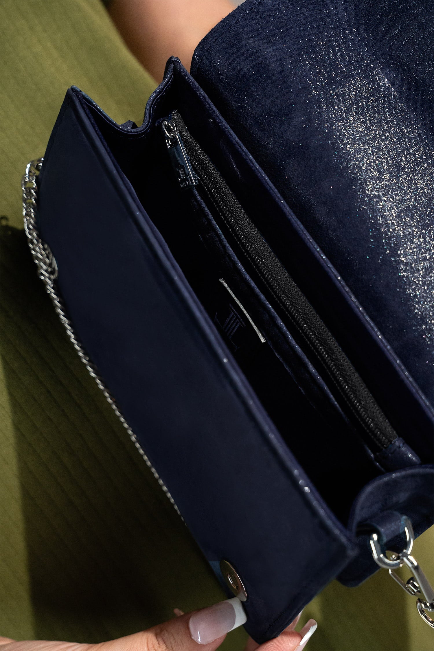 Womens leather shoulder clutch bag in dark blue colour with satin piping and rhinestone brooch by JULKE.