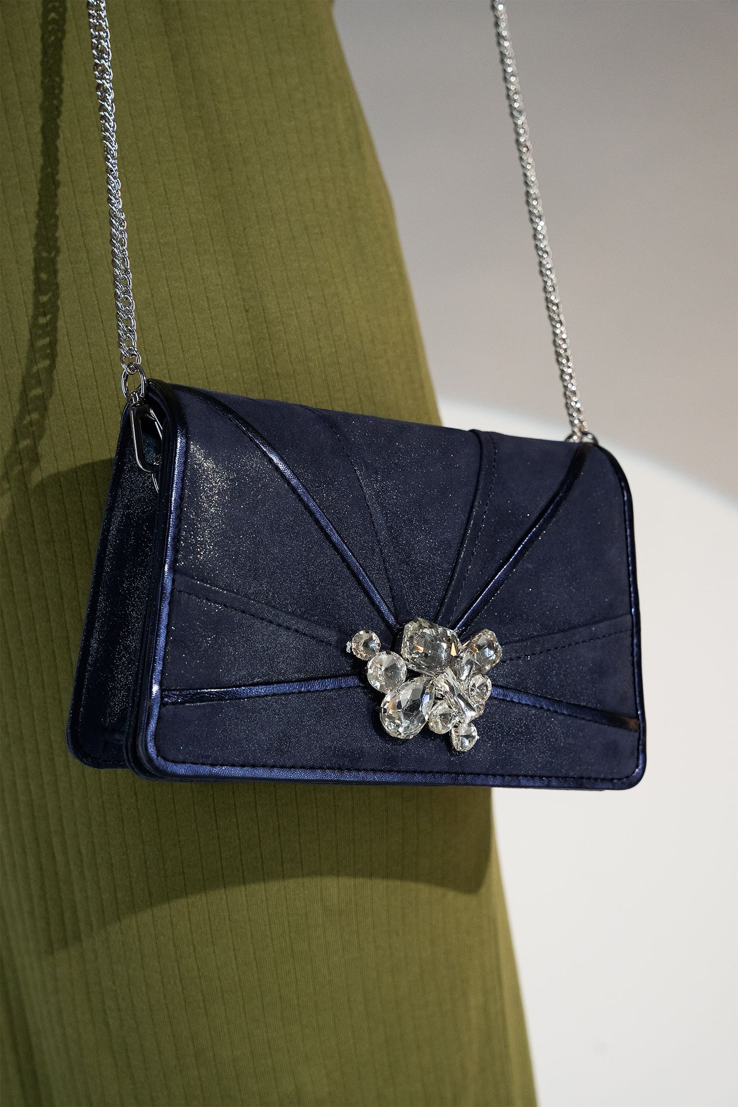 Womens leather shoulder clutch bag in dark blue colour with satin piping and rhinestone brooch by JULKE.