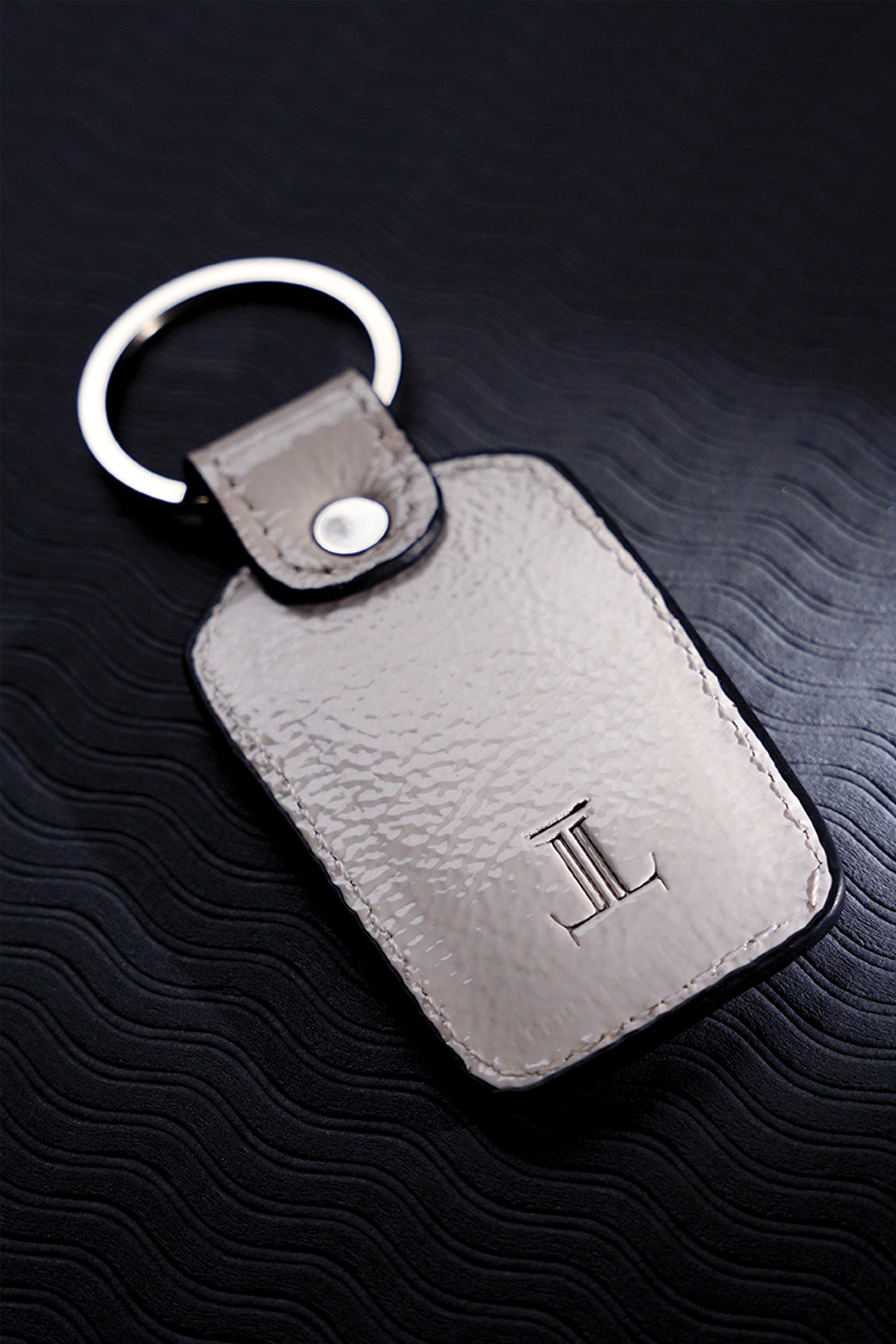 Leather key chain in white colour with weaving and metal ring by JULKE