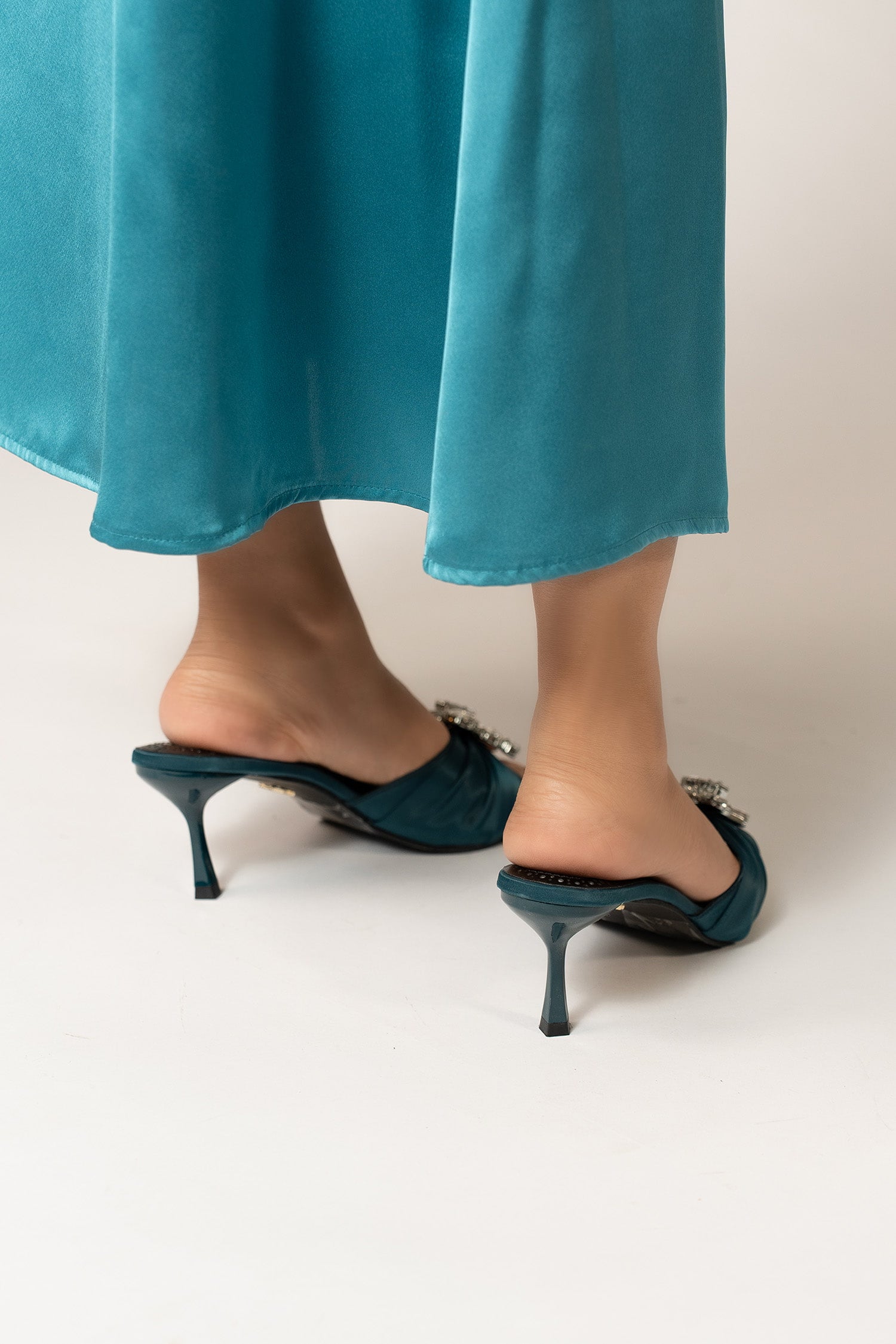 Womens mule heel shoes in blue green colour with pleated satin strap and large rhiestone brooch by JULKE.