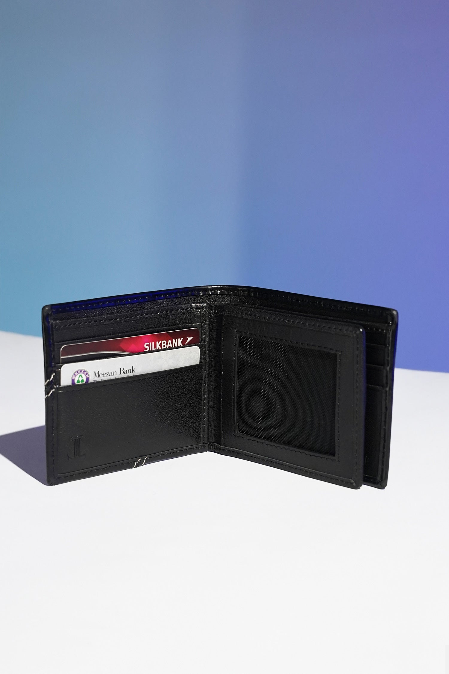 Mens leather bifold wallet in black colour with white contrast stich and metallic hardware by JULKE