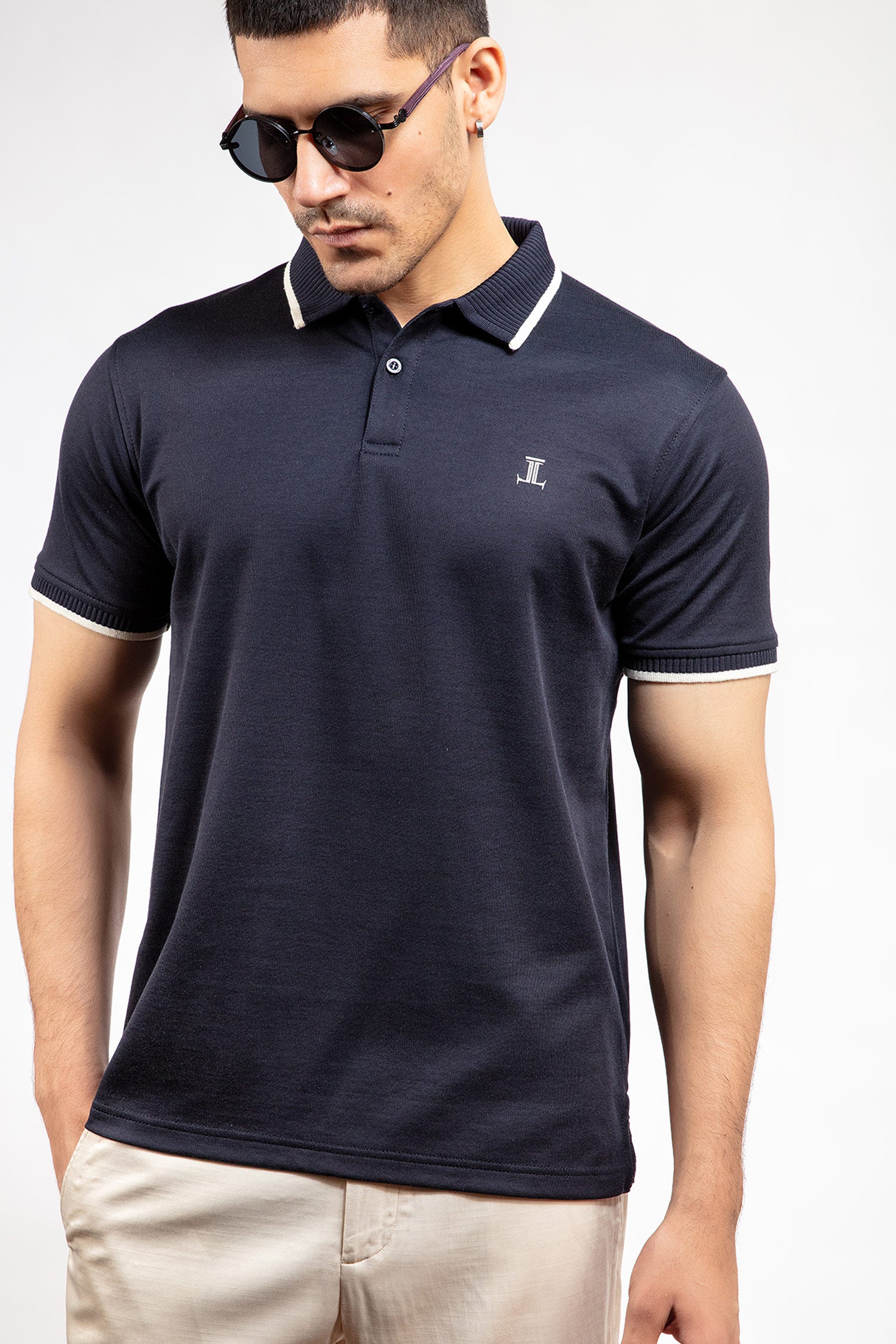 Mens summer polo shirt in navy blue colour with matching white outline tipped collar and half sleeves by JULKE.