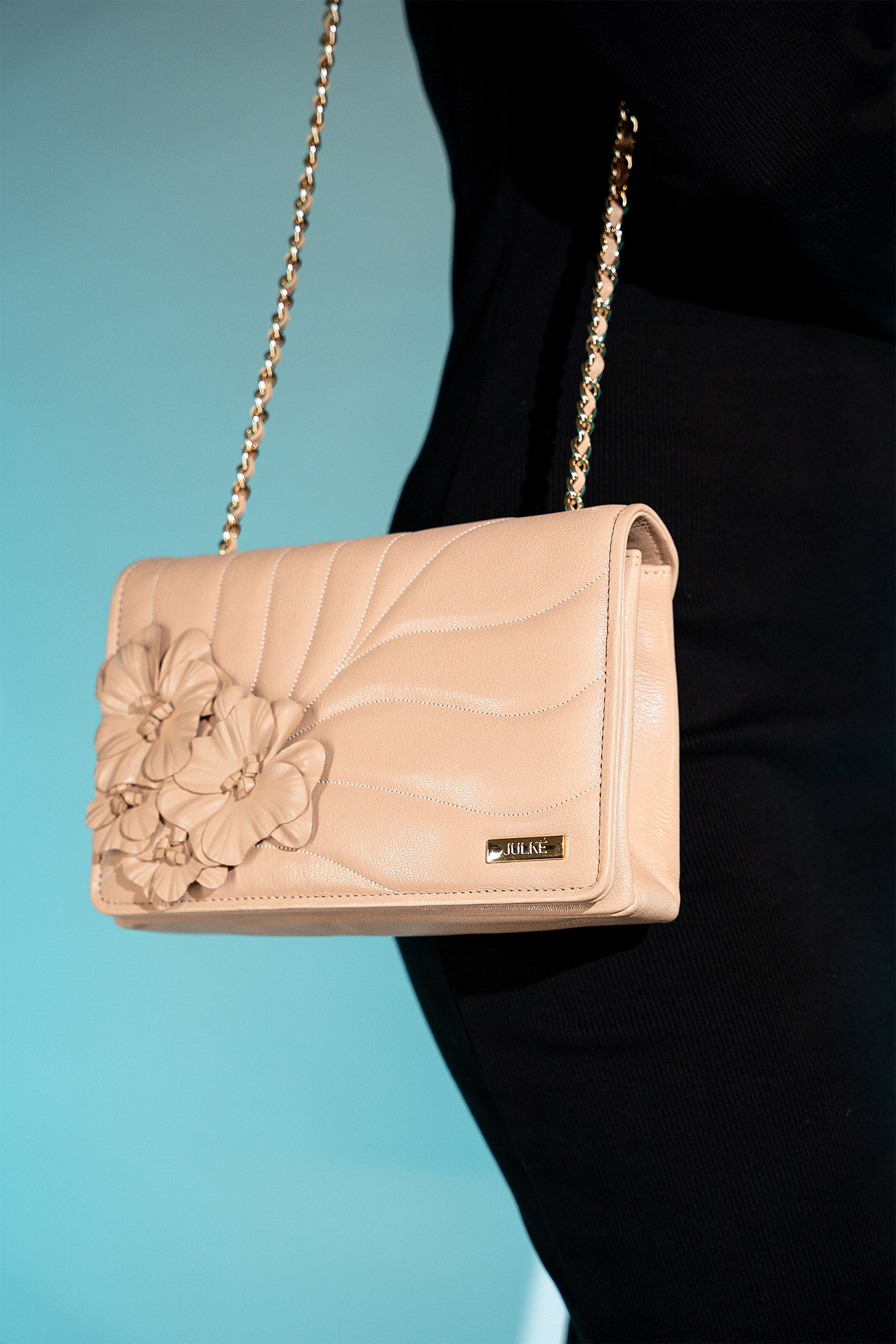 Women's leather shoulder bag in beige brown colour with quilting and leatherette flower brooch by JULKE.