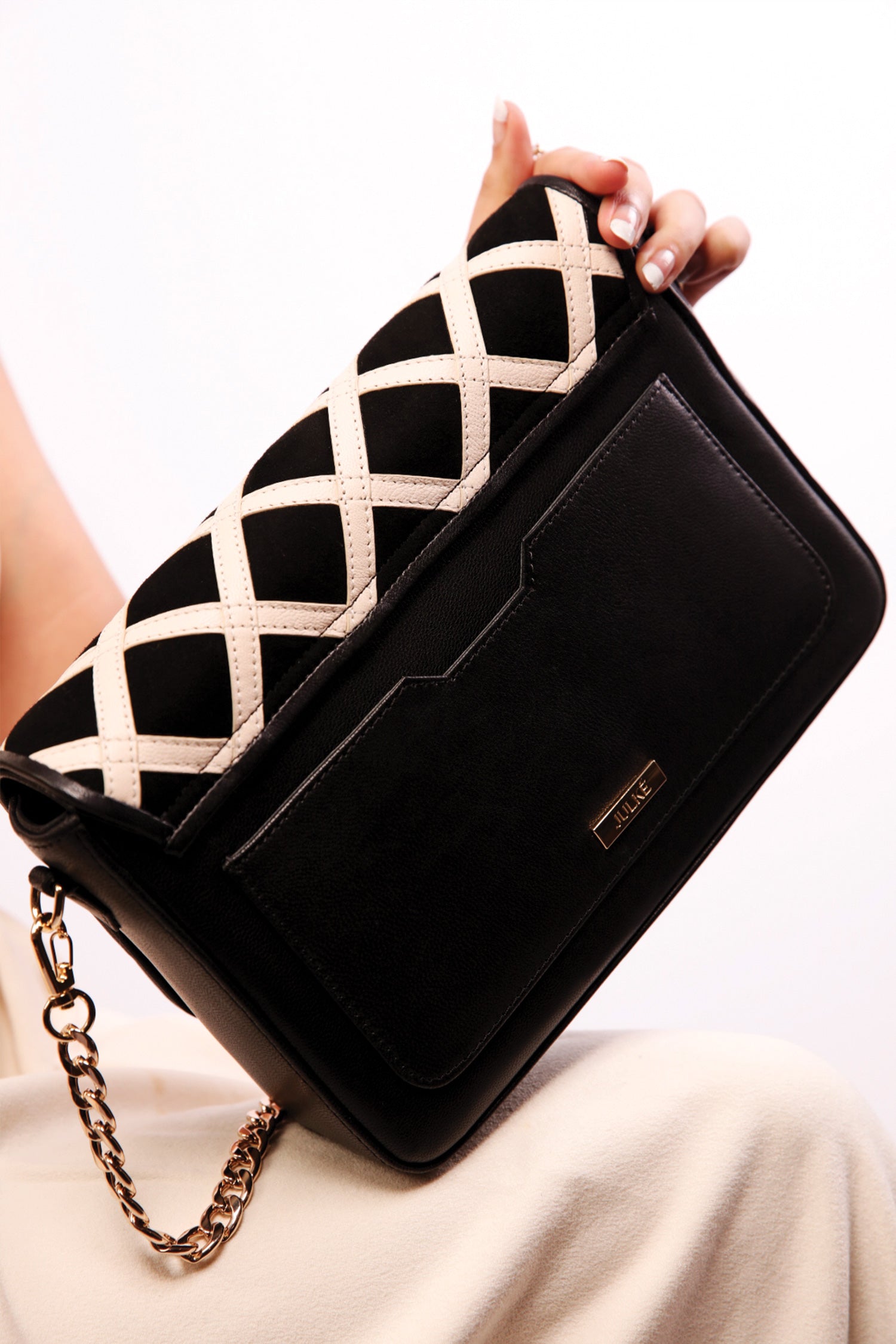 Womens leather shoulder bag in beige and black colour with quilted straps and gold chain by JULKE