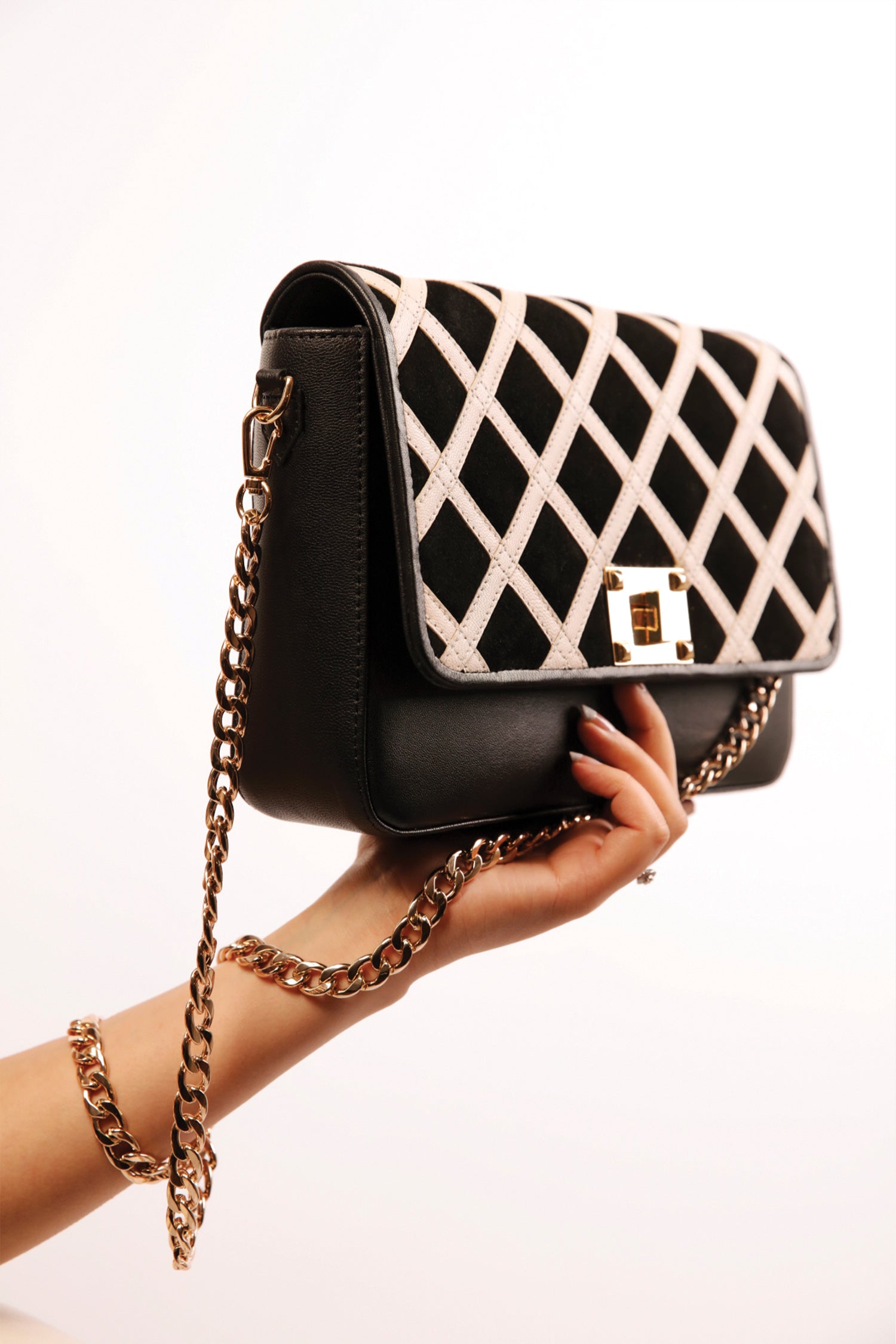 Womens leather shoulder bag in beige and black colour with quilted straps and gold chain by JULKE