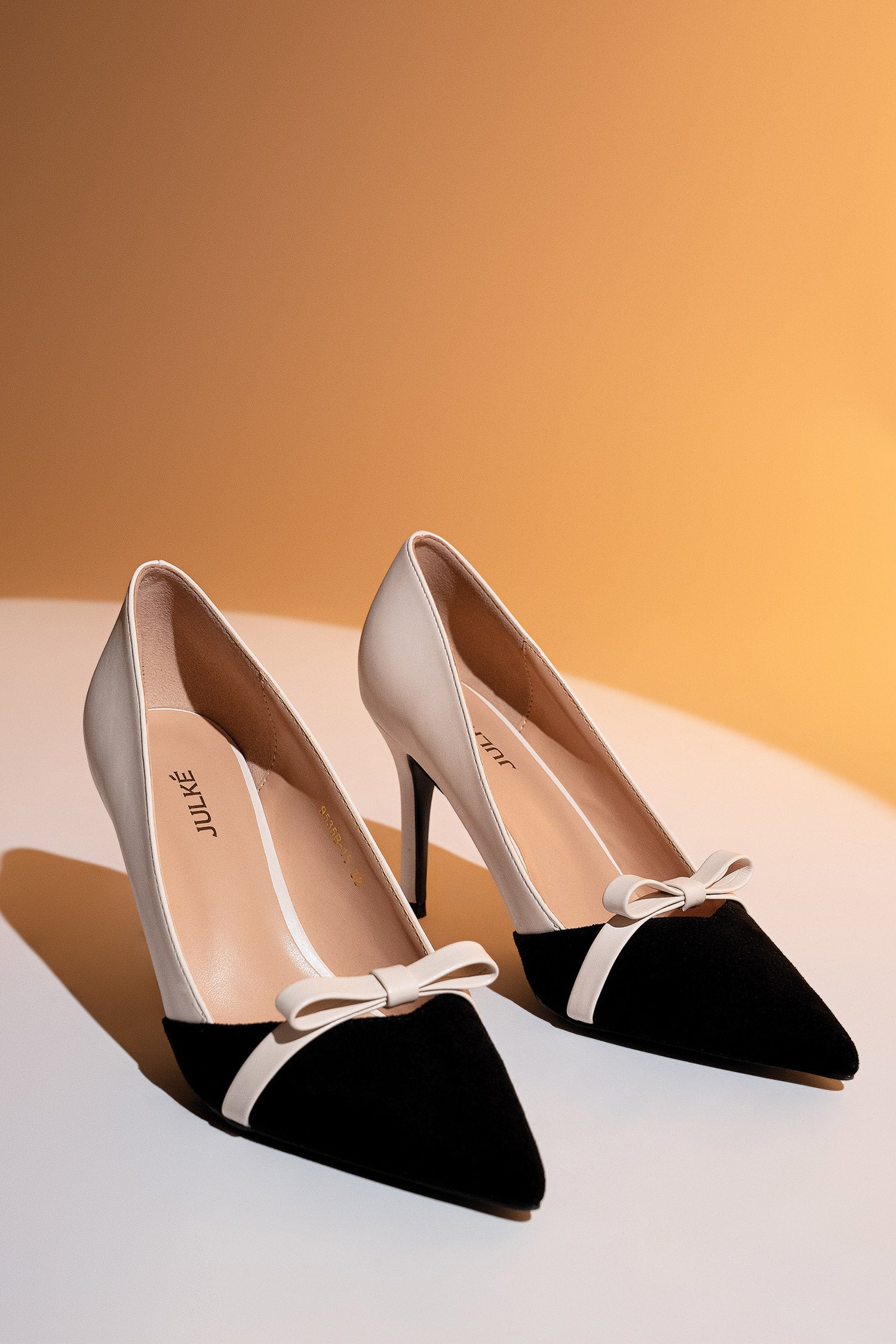 Women heels in off white colour with pointed suede toe and bow by JULKE