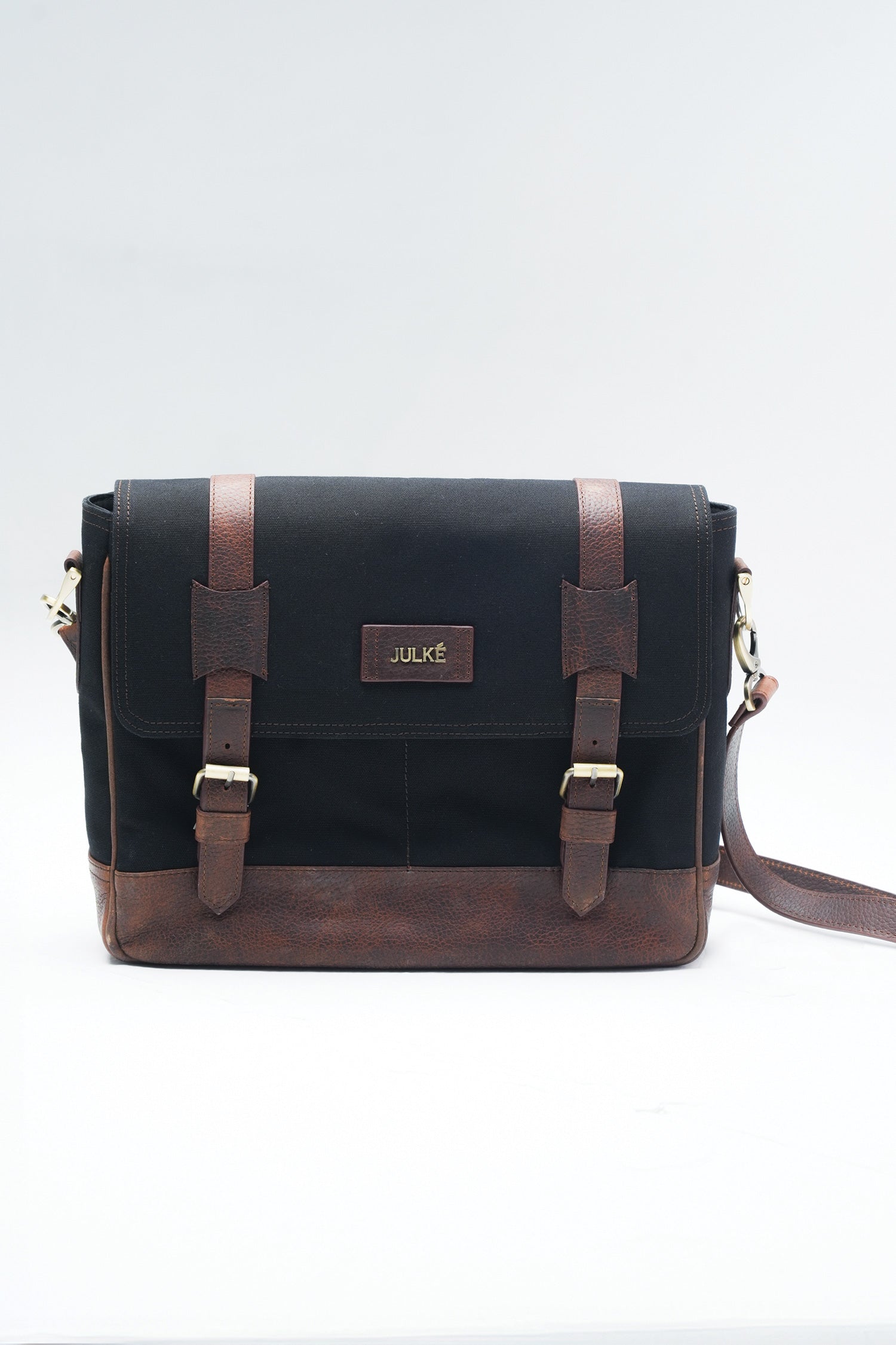 Mens leather and canvas laptop messenger bag in black and rust colour with detachable shoulder strap by JULKE