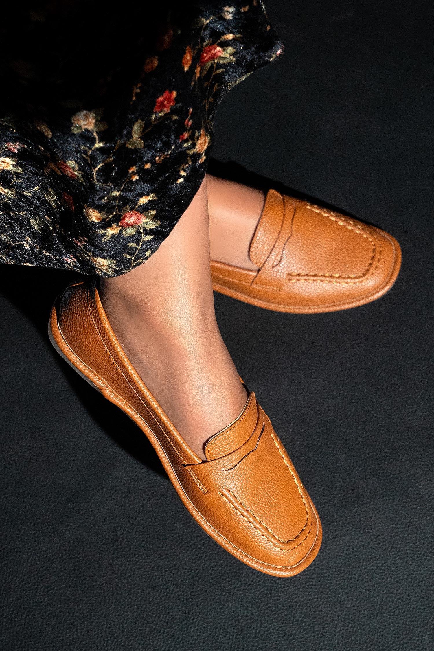 Women's flat moccasin style shoes in brown colour and leather texture with flexible transparent rubber sole and padded in-socks by JULKE.