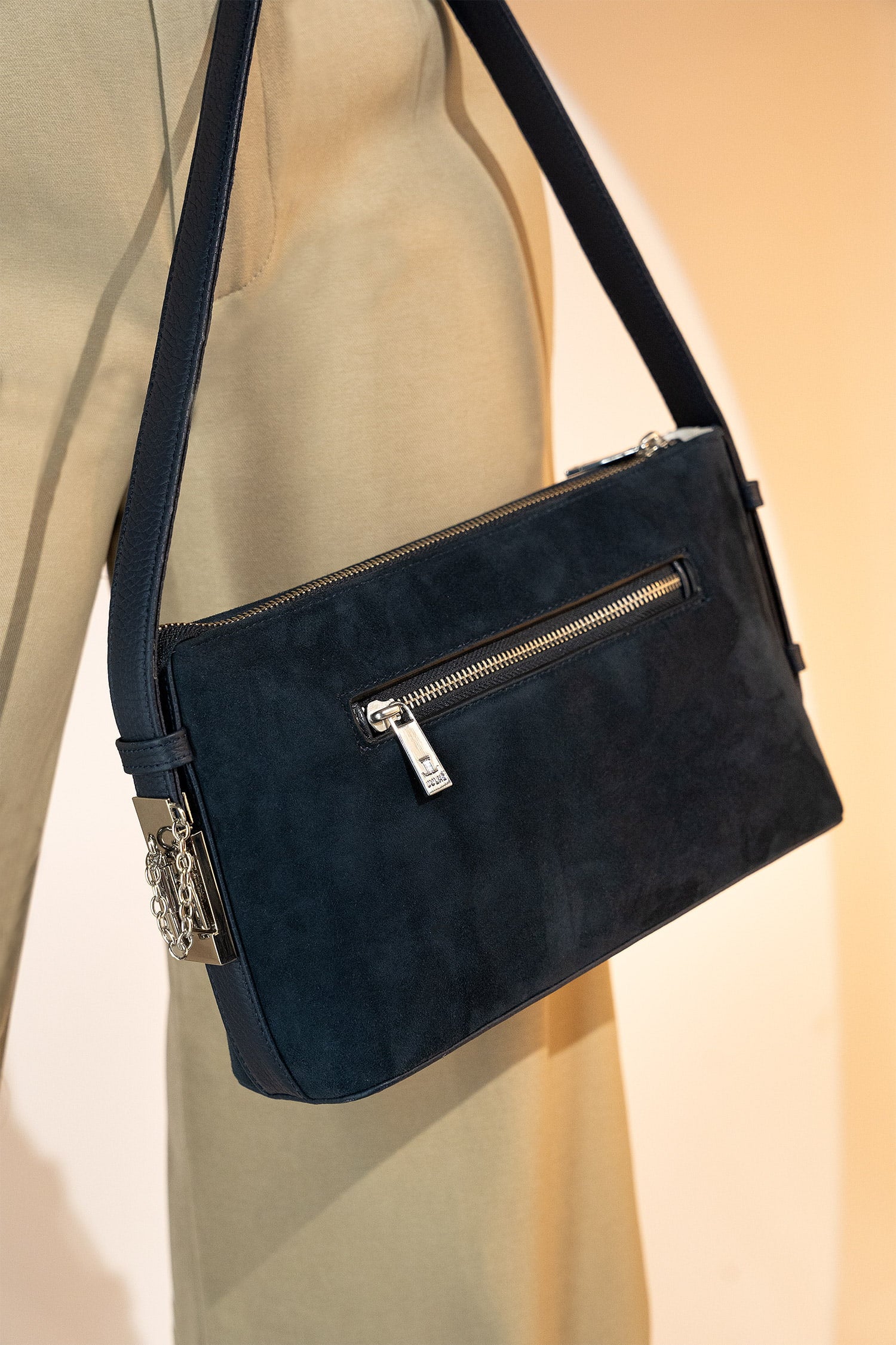 Women's suede leather mini shoulder bag in navy blue colour with contrast shoulder strap and metallic side lock by JULKE.