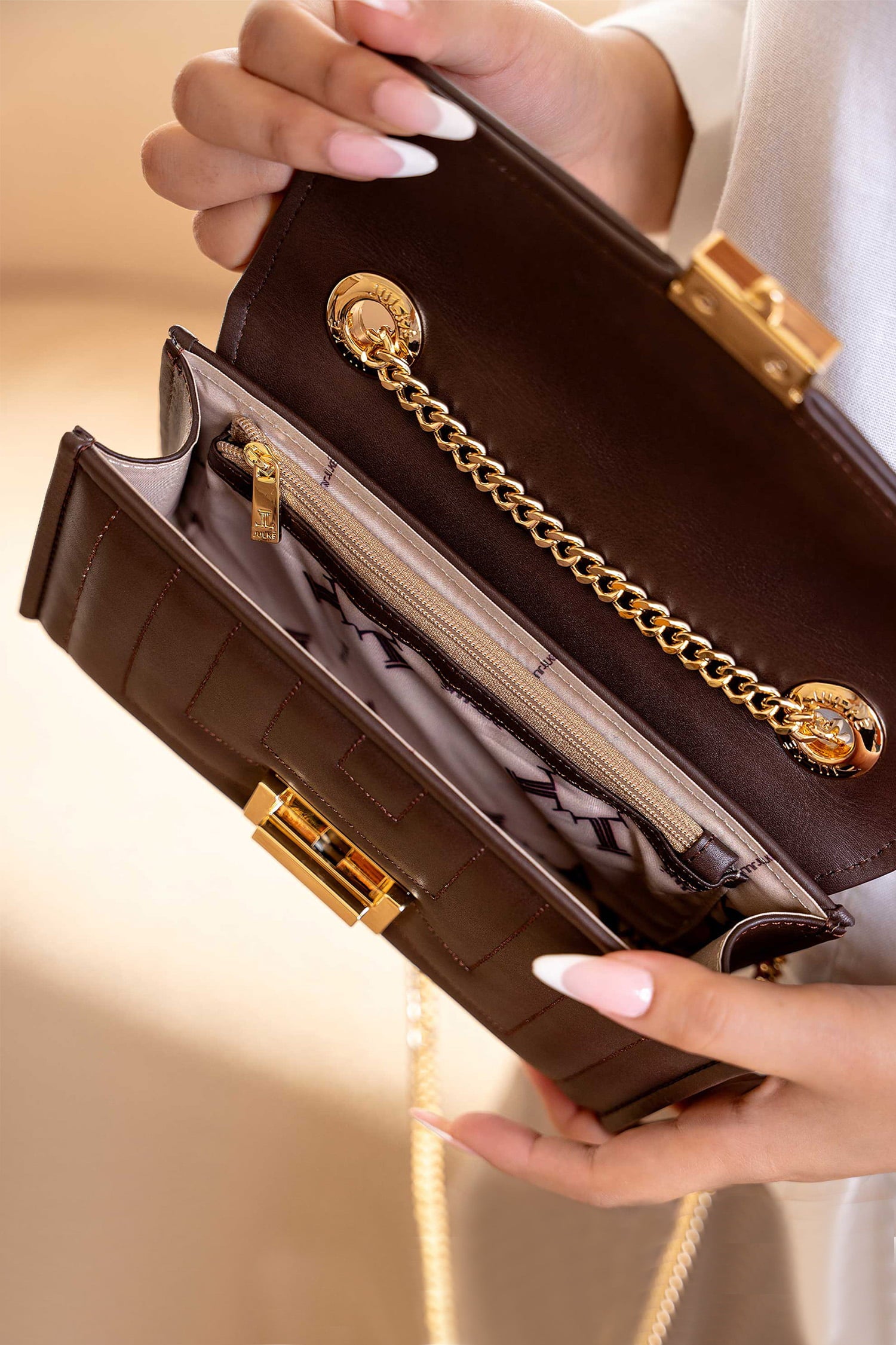 Womens leeather shoulder clutch bag in dark brown colour with weaving quilted front flap and metallic gold hardware by JULKE.