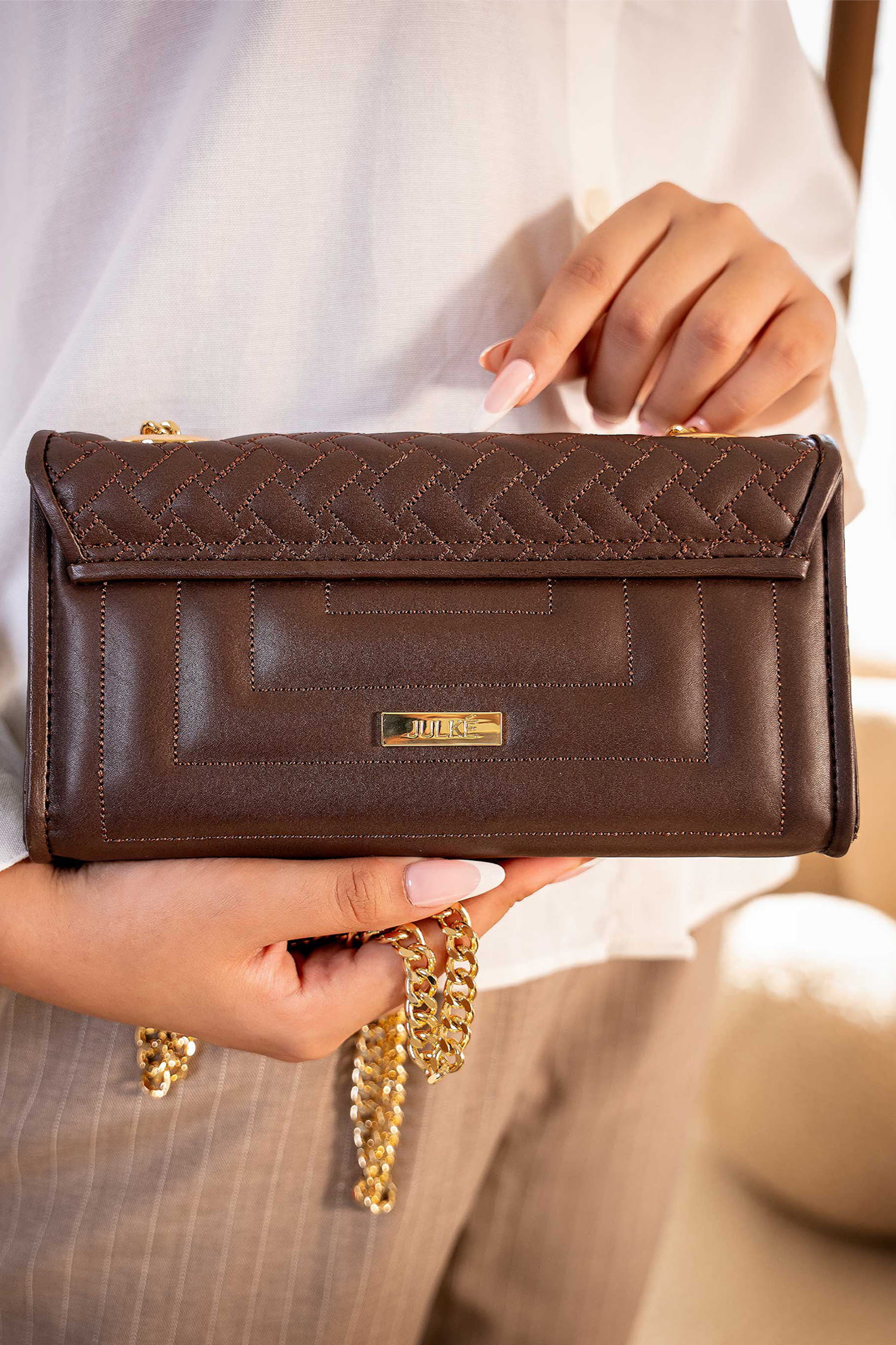 Womens leeather shoulder clutch bag in dark brown colour with weaving quilted front flap and metallic gold hardware by JULKE.
