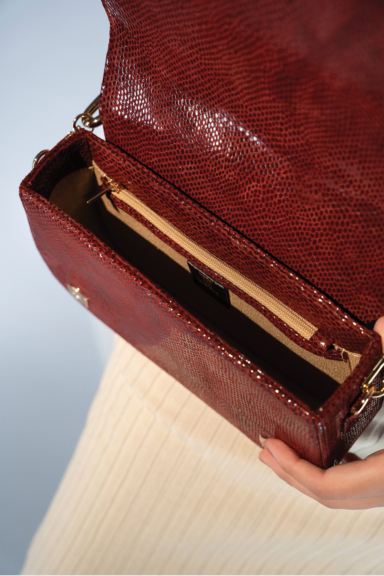 Women's leather top handle shoulder bag in dark red colour with snake print & texture by JULKE