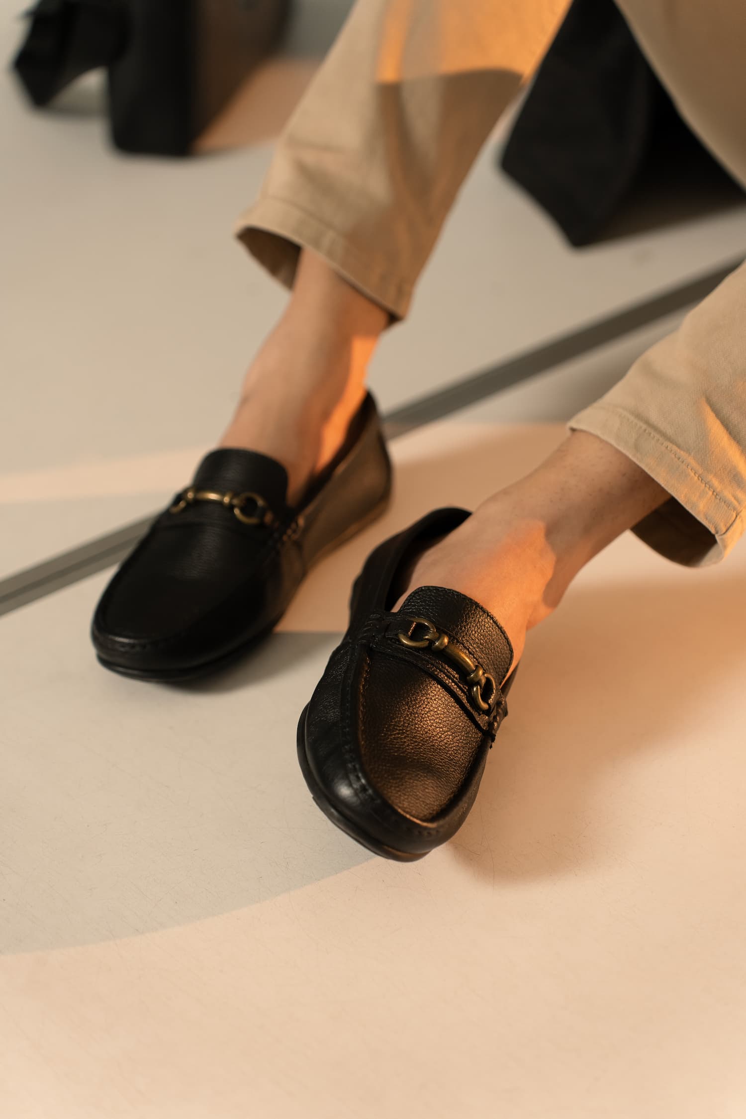 Mens Milled grain leather moccasins in black colour with metallic antique gold horsebit buckle by JULKE.