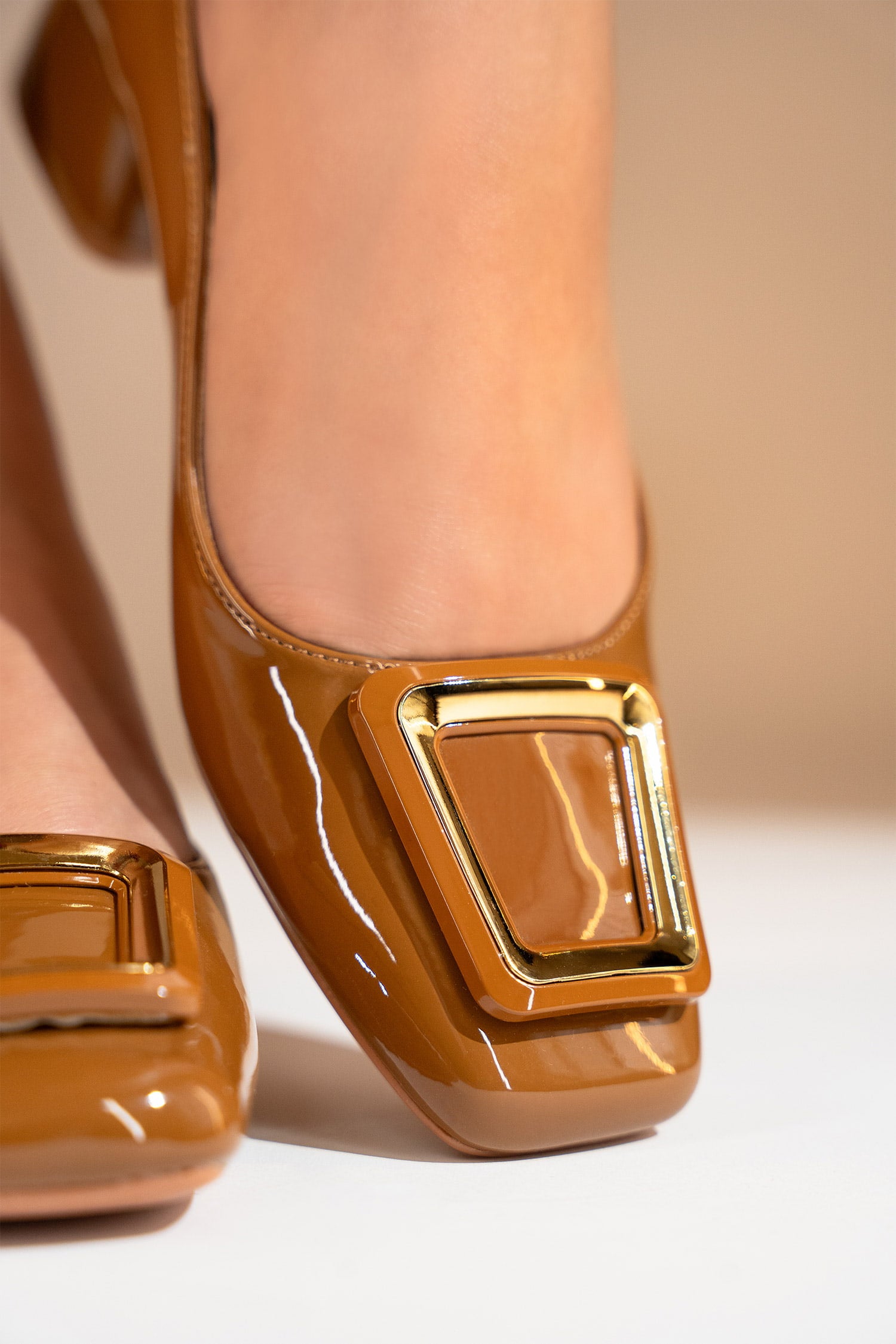 Women's brown block heel pumps with square toe in glossy patent material with matching geometric buckle by JULKE.