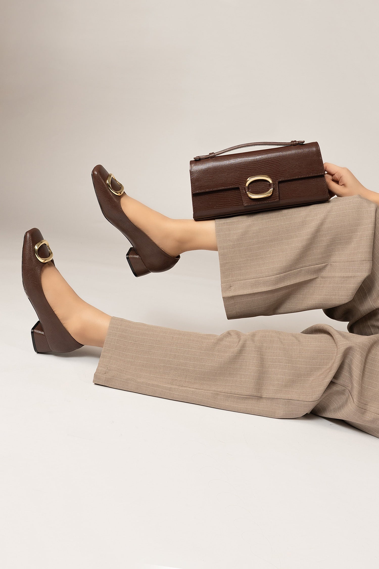 Womens square toe block heels in dark brown colour with reptile texture and matching leather bag with metallic golden buckle by JULKE.
