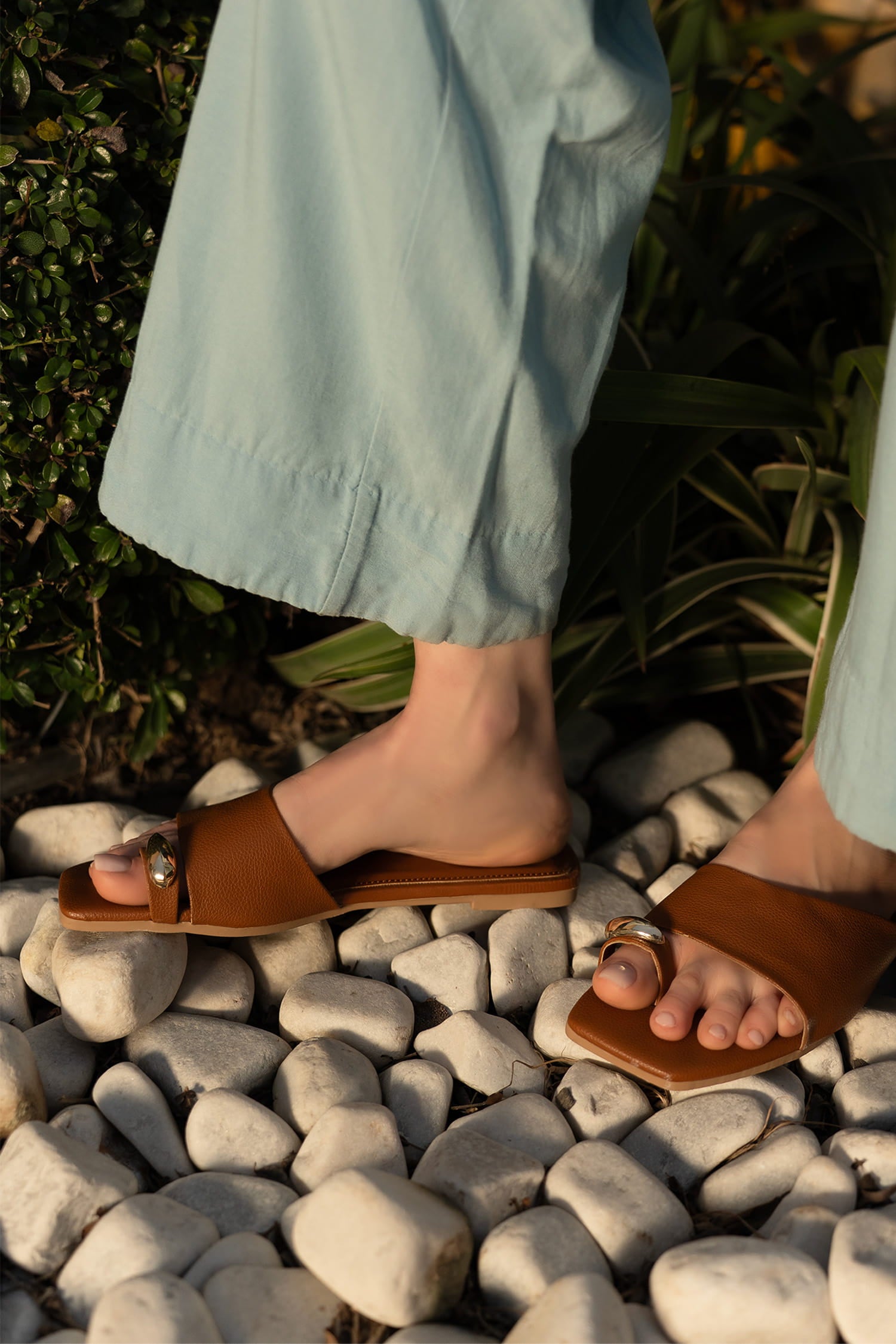 Womens flat slides in brown colour with toe strap and metallic golden toe ornament by JULKE.