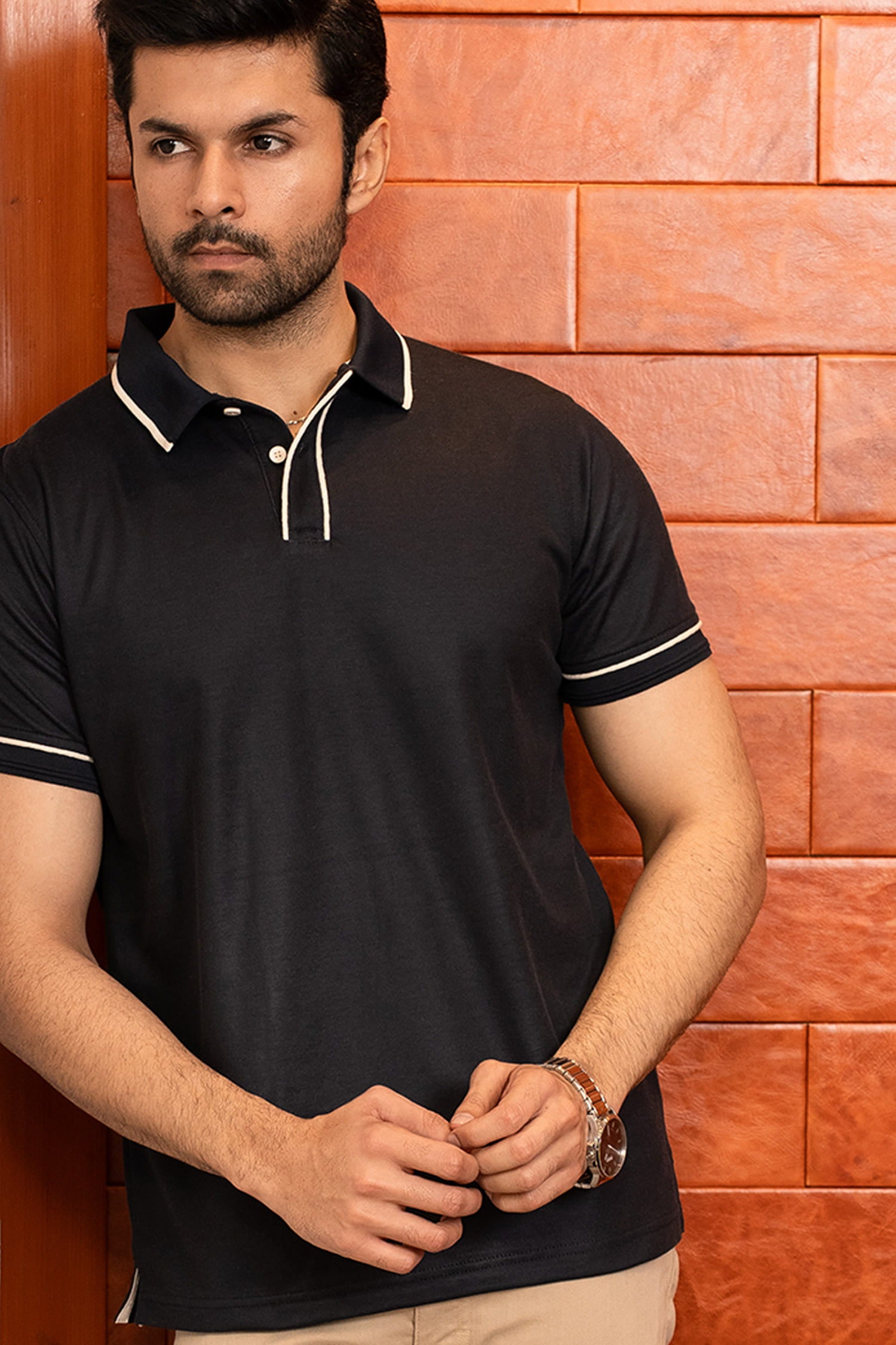 Mens half sleeve polo shirt in black colour with white buttons and white contrast tipping at collar placket and sleeves by JULKE.