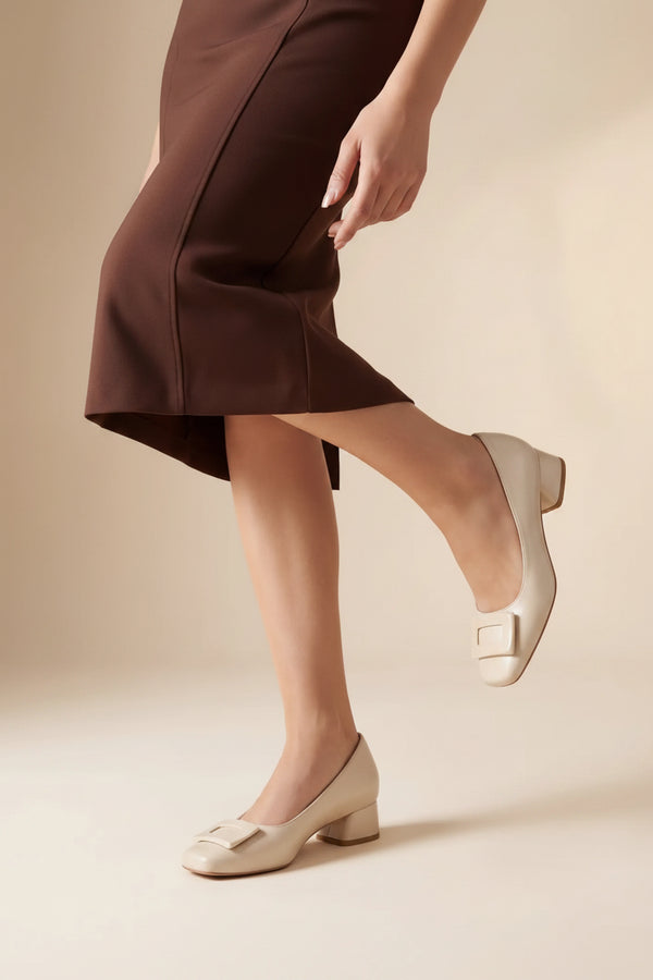 Person wearing white shoes with a neutral background