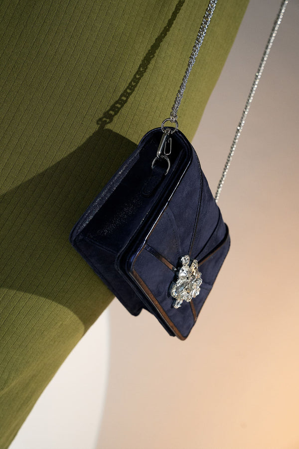 Womens leather shoulder clutch bag in dark blue colour with satin piping and rhinestone brooch by JULKE. 