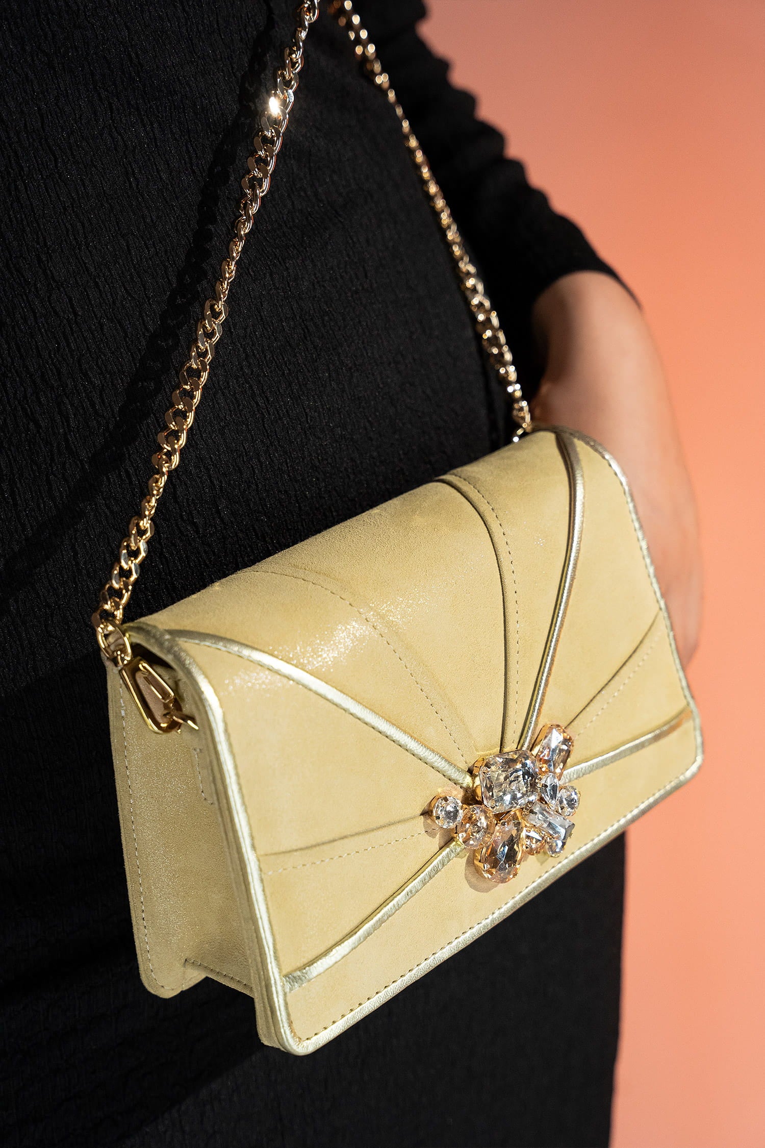 Womens leather shoulder clutch bag in light gold colour with satin piping and rhinestone brooch by JULKE. 