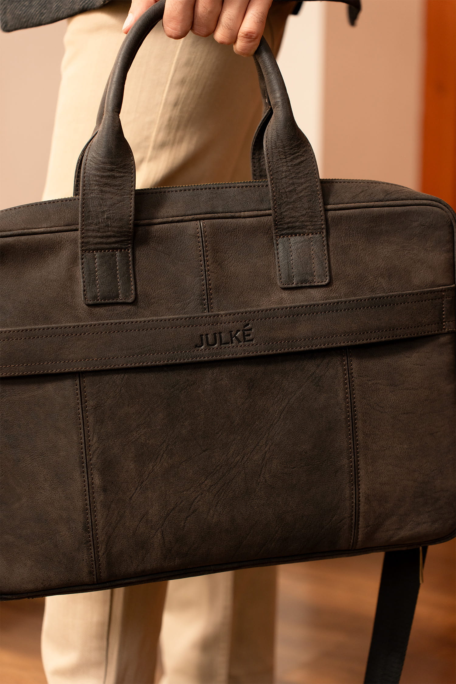 Mens nubuck leather laptop bag in dark brown colour with frotn contrast stitch and detachable shoulder strap by JULKE. 