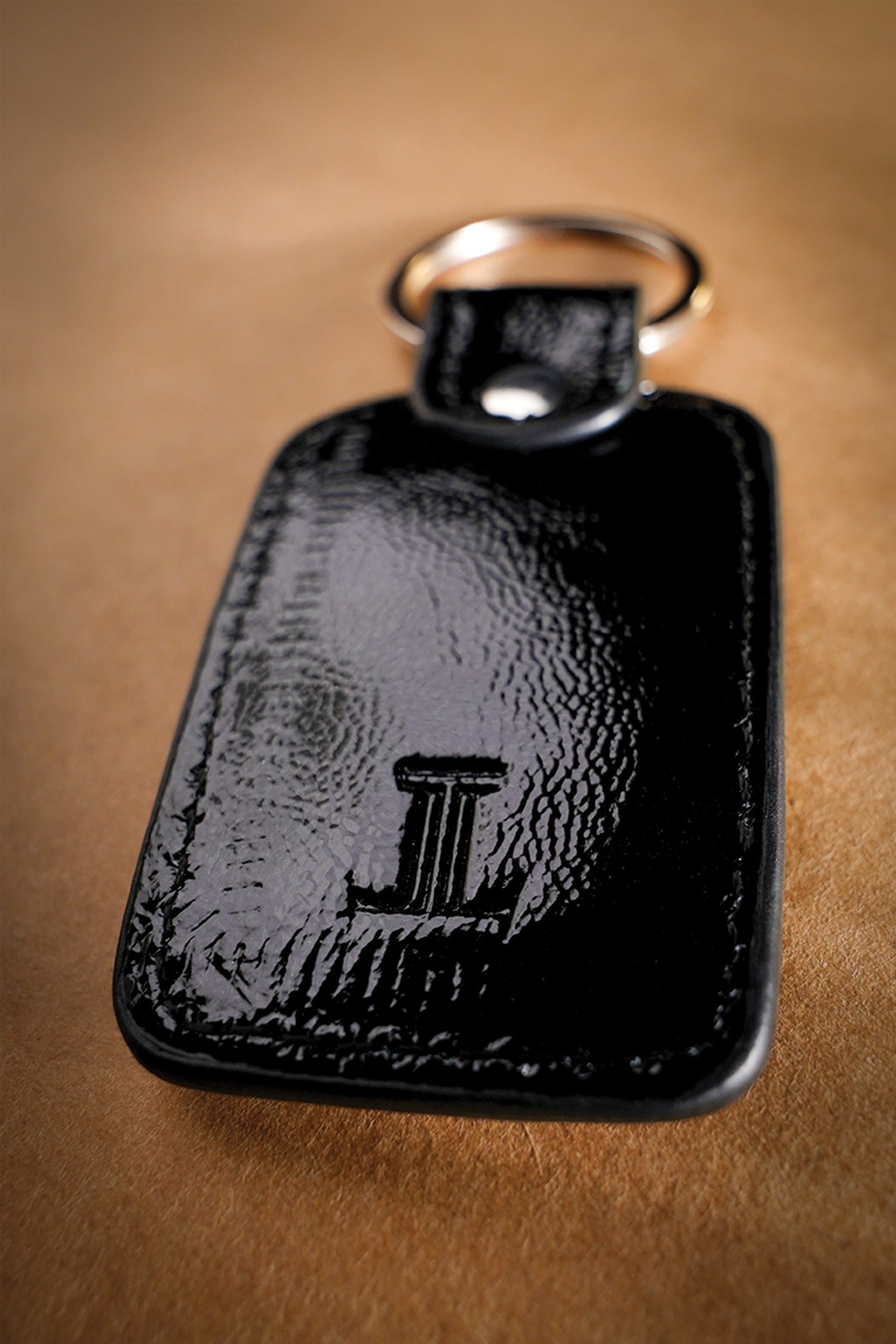 Leather key chain in black colour with weaving and metal ring by JULKE