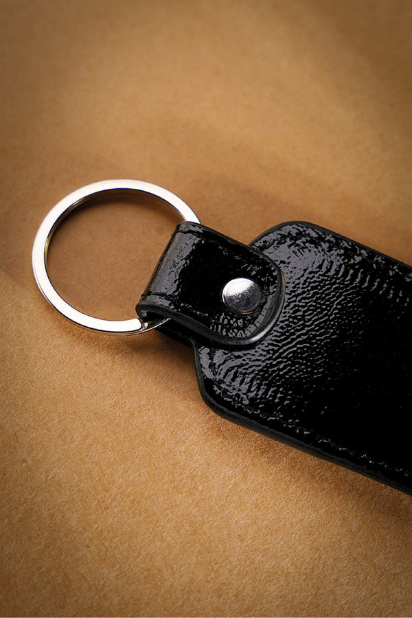 Leather key chain in black colour with weaving and metal ring by JULKE