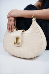 Womens leather shoulder baguette bag with croco texture and gold chain in off white colour by JULKE