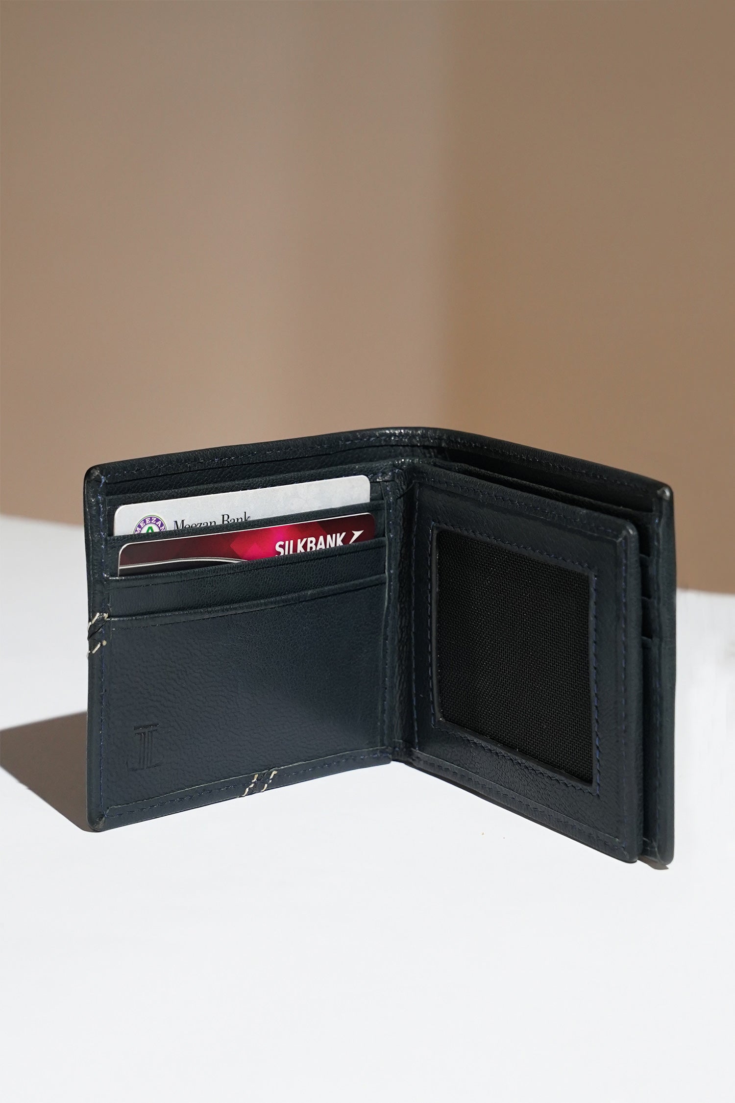Mens leather bifold wallet in dark blue colour with white contrast stich and metallic hardware by JULKE