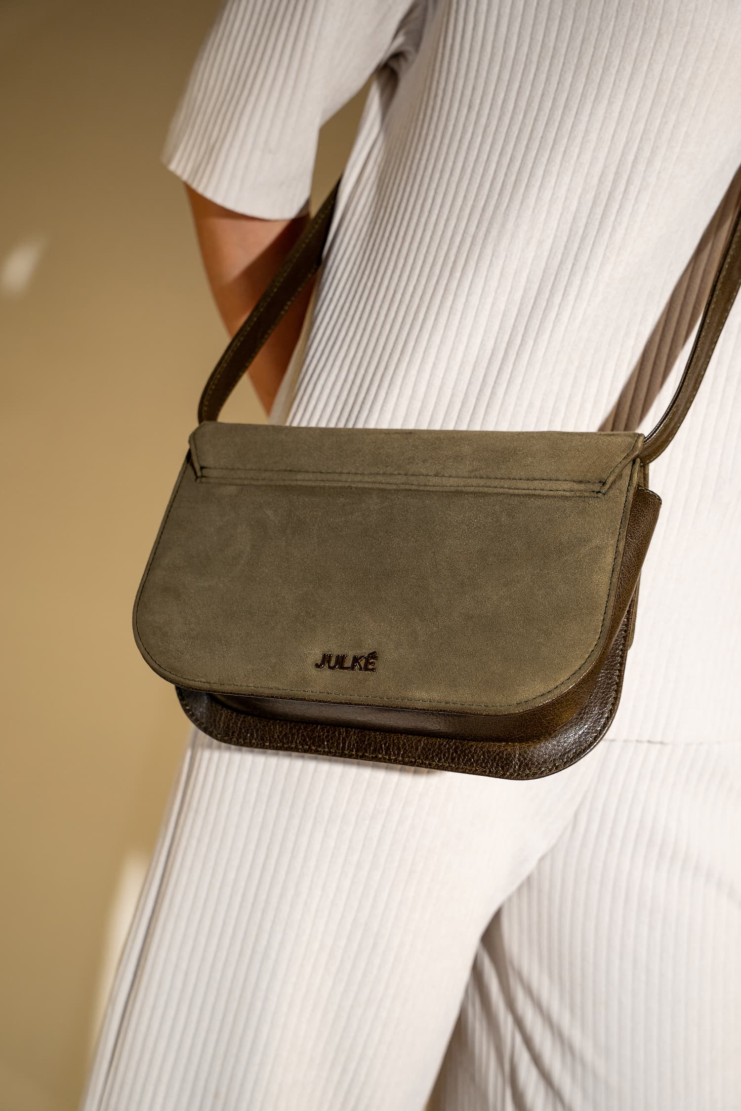 Womens suede & leather crossbody shoulder bag in olive green colour with adjustabl shoulder strap and unqiue metallic gold push lock by JULKE 