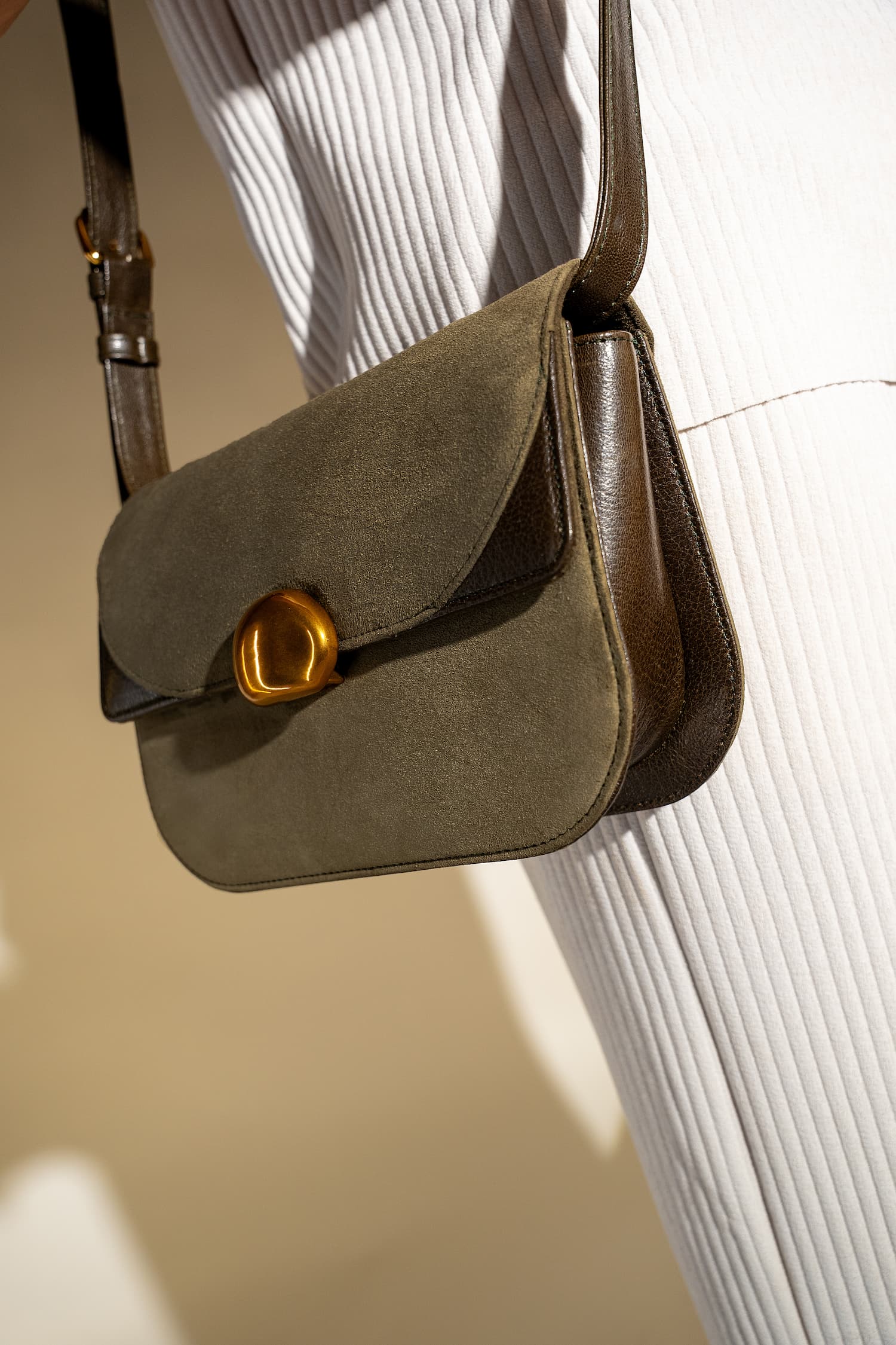 Womens suede & leather crossbody shoulder bag in olive green colour with adjustabl shoulder strap and unqiue metallic gold push lock by JULKE 