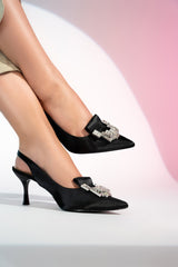 Women's sling back pointed toe heels in black colour satin with geometric white rhinestone brooch by JULKE
