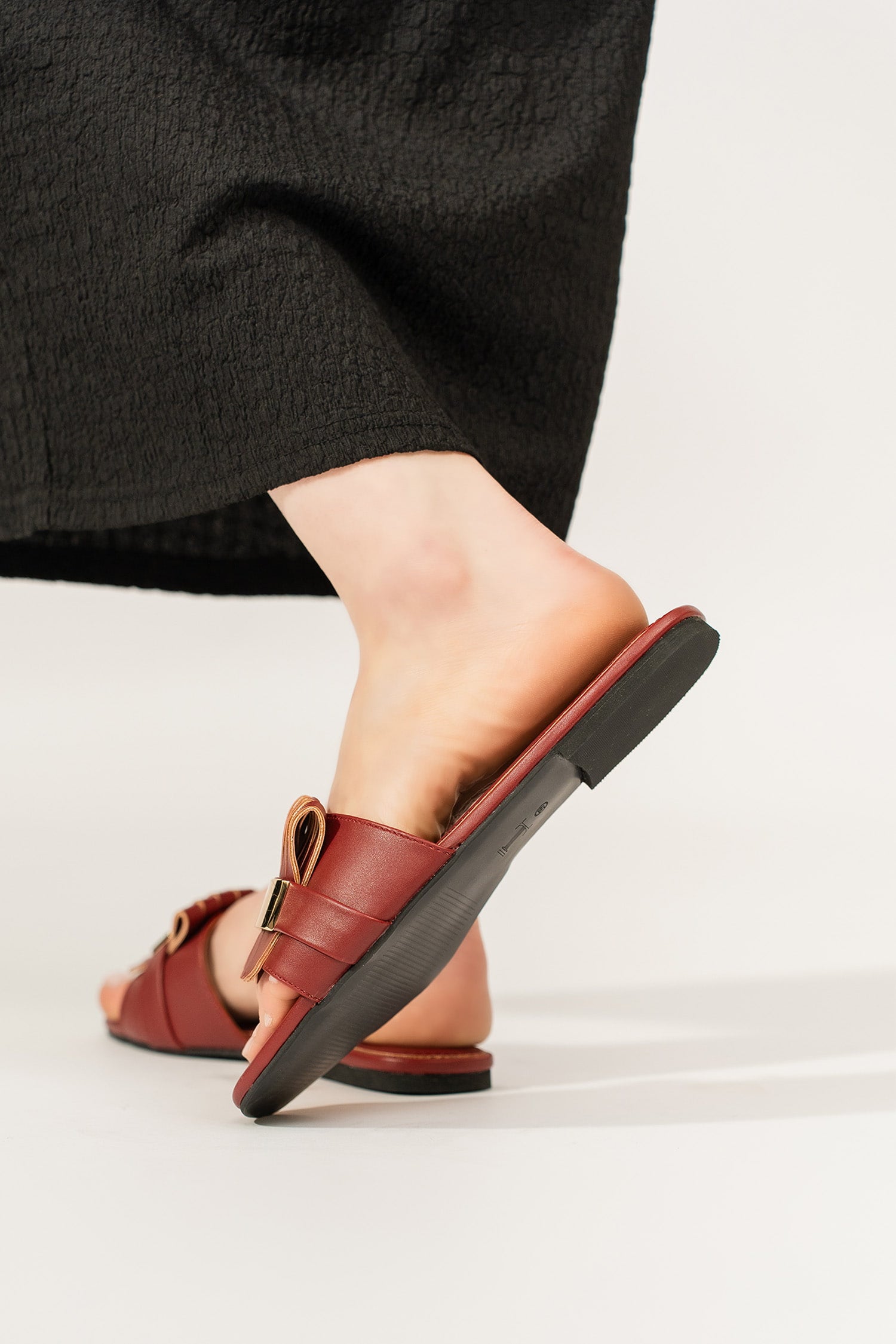 Womens leather flat shoes in dark maroon colour with matching fringe and metallic gold leather strap by JULKE. 