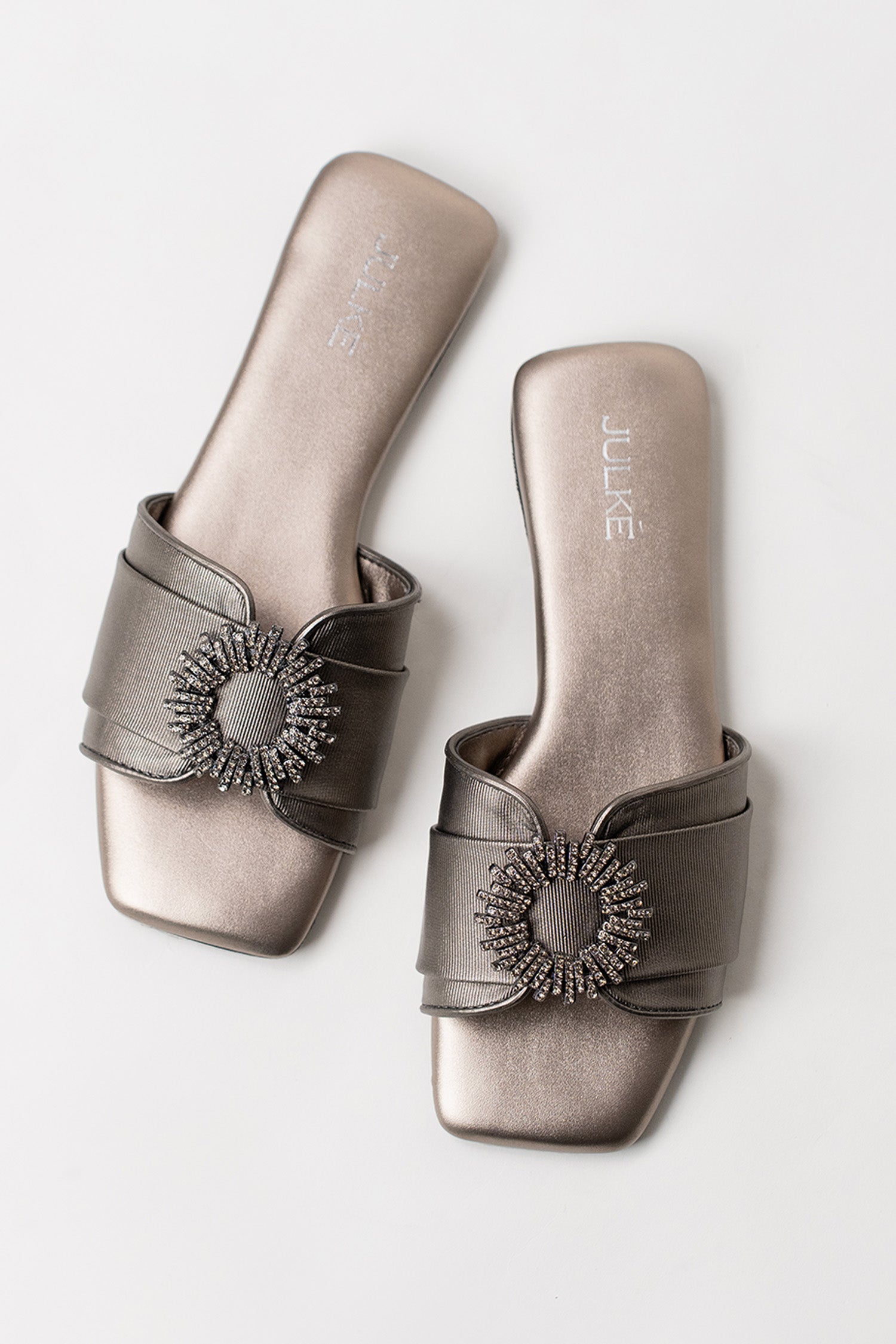 Women's festive leatherite flat shoes in gun metal colour with round silver diamante brooch and padded insock by JULKE. 