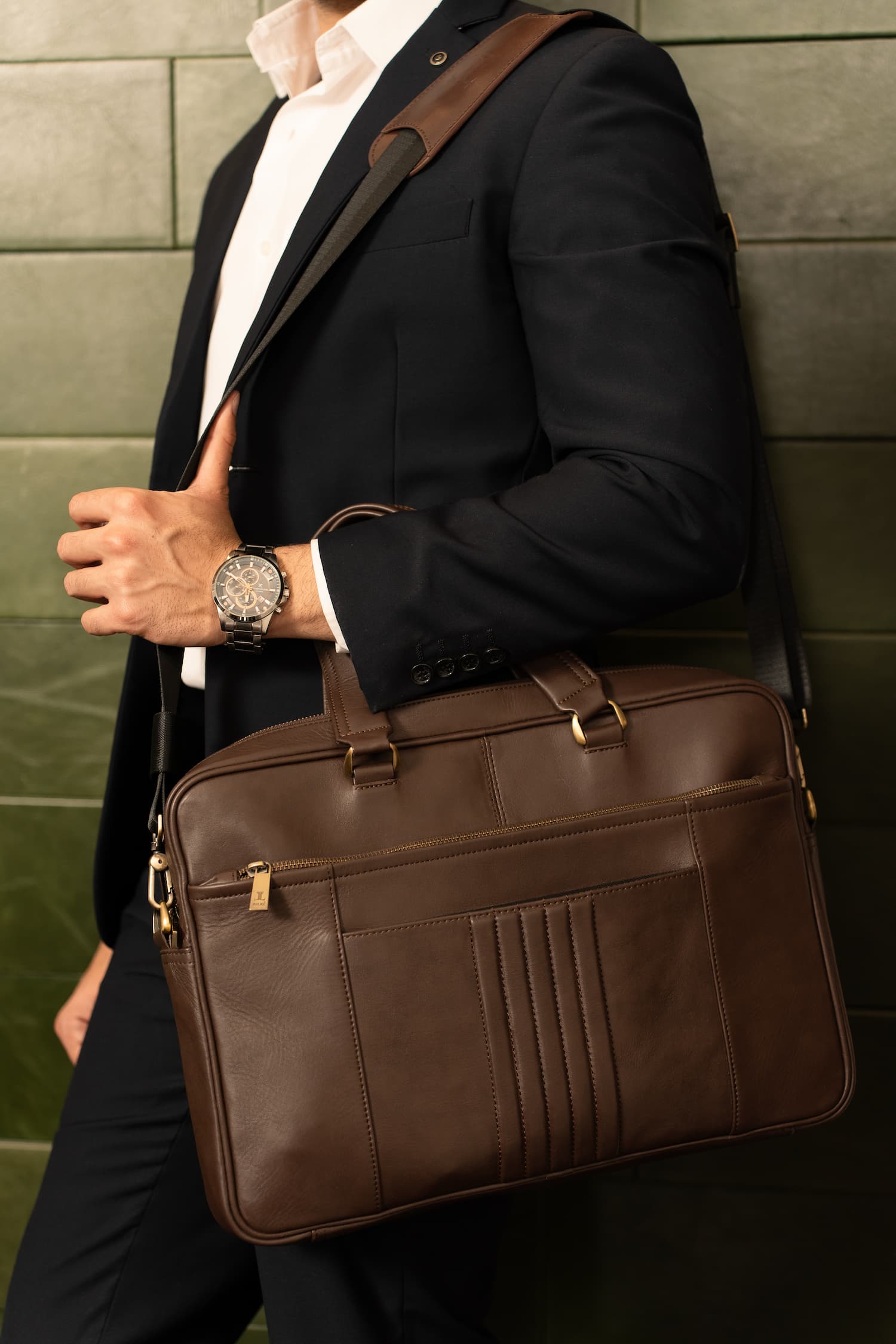 Mens full grain leather laptop bag in dark brown colour with etxra compartments and metallic gold hardware by JULKE. 