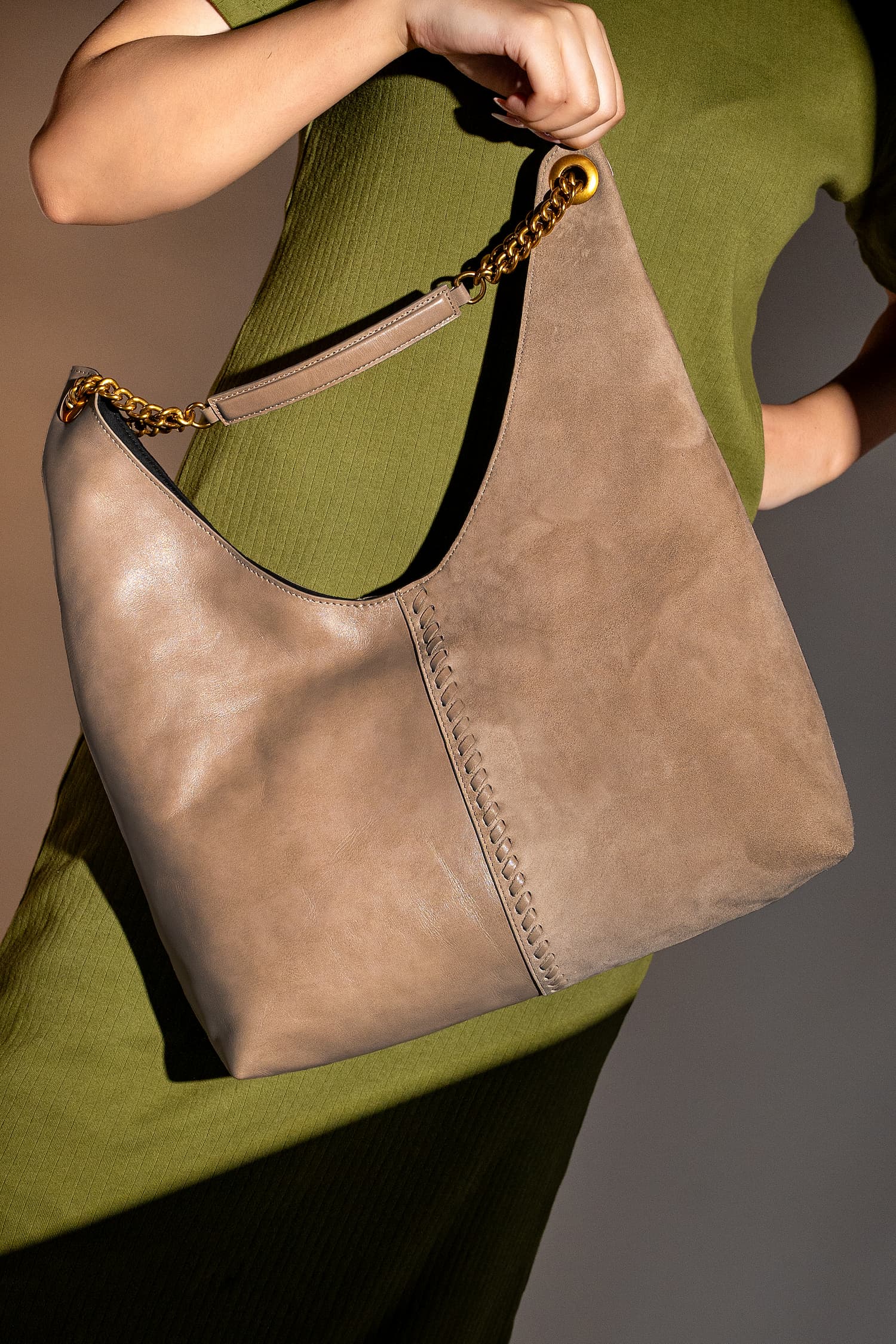 Women's leather hobo shoulder bag in grey brown colour with metallic gold chain shoulder strap and woven front panels by JULKE 