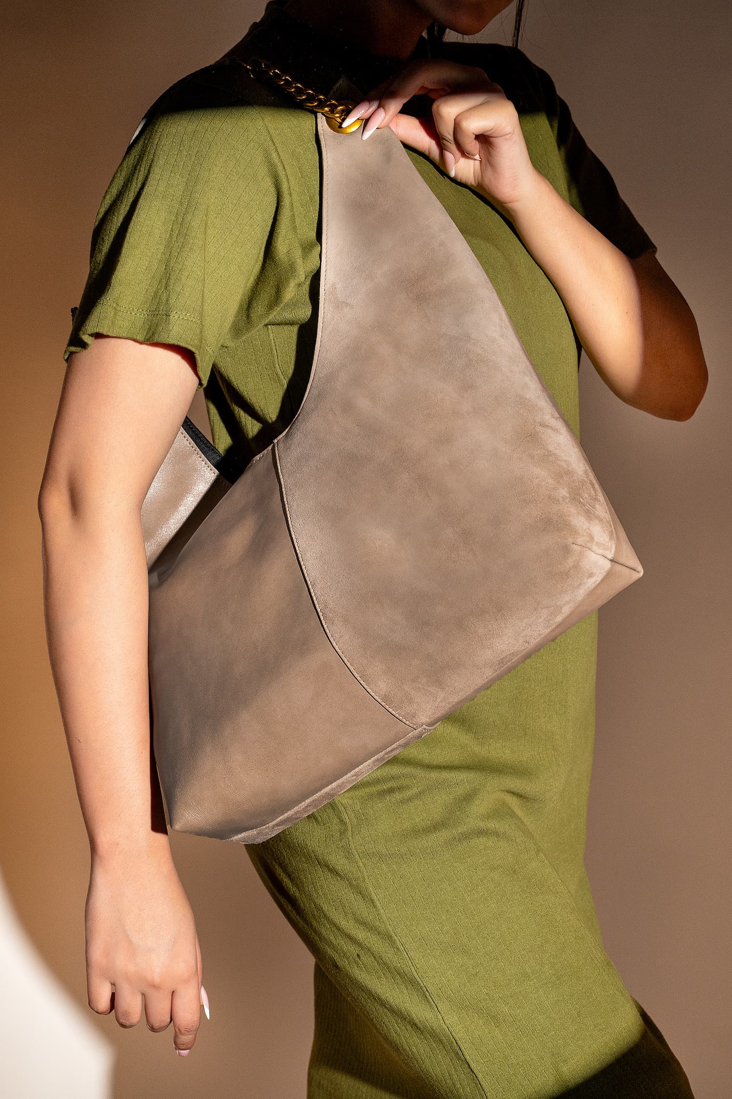 Women's leather hobo shoulder bag in grey brown colour with metallic gold chain shoulder strap and woven front panels by JULKE 