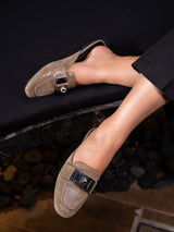 Elegant women’s slip-on Loche mules by JULKÉ crafted in glossy leather with a statement metallic buckle, styled for modern sophistication and everyday ease.