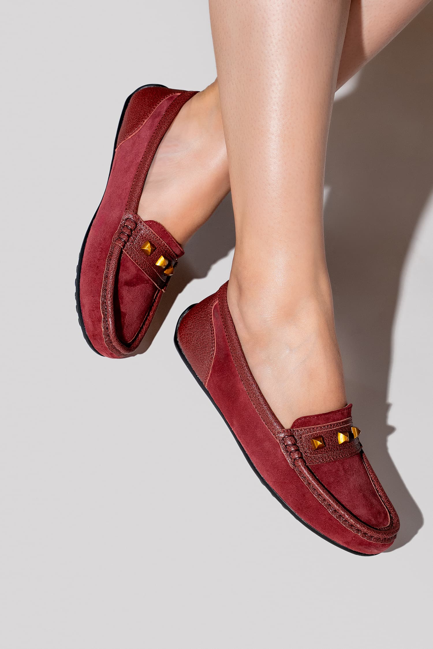 Womens suede leather moccasins in dark  red colour with metallic gold studs by JULKE. 