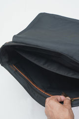 Mens leather and canvas laptop messenger bag in black and rust colour with detachable shoulder strap and pockets by JULKE