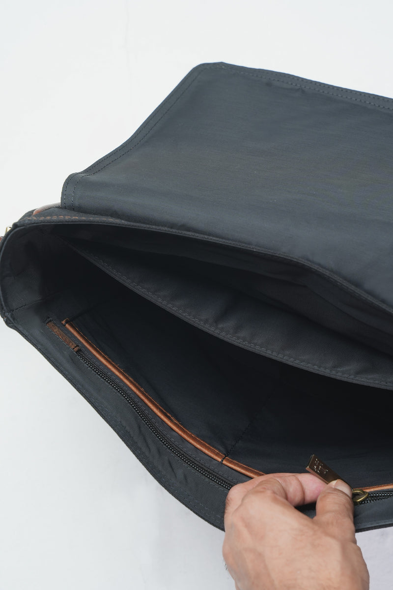 Mens leather and canvas laptop messenger bag in black and rust colour with detachable shoulder strap and pockets by JULKE