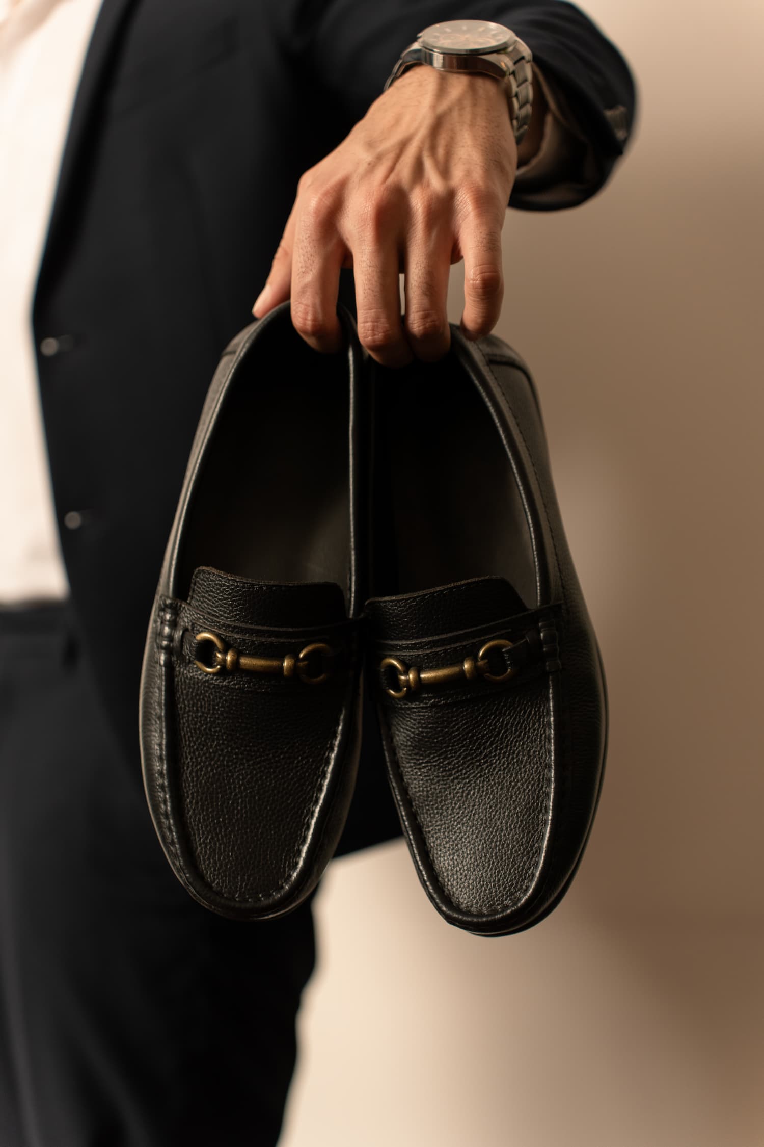 Mens Milled grain leather moccasins in black colour with metallic antique gold horsebit buckle by JULKE. 