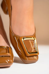Women's brown block heel pumps with square toe in glossy patent material with matching geometric buckle by JULKE.
