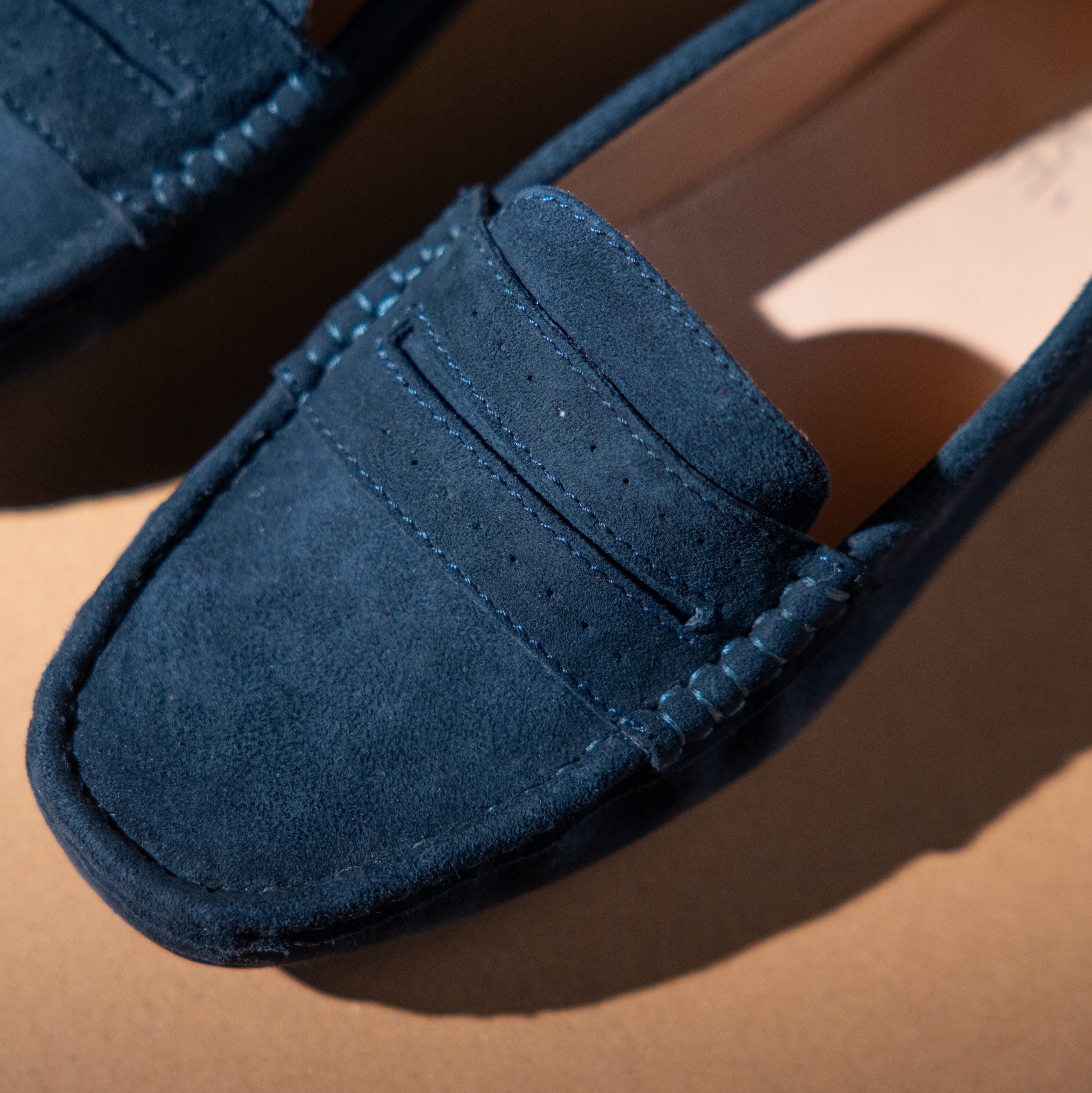 Women's winter suede leather moccasins in dark blue colour with metal logo trim and moc toe by JULKE 