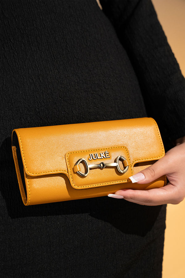 Women's leather long wallet in mustard yellow colour in envelope shape with long pockets and metallic horse-bit buckle and brand logo by JULKE. 