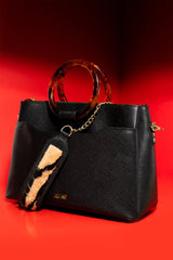 Womens leather shoulder bag with fur strap and plastic round handle in black colour by JULKE