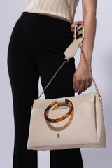 Womens leather shoulder bag with fur strap and plastic round handle in beige colour by JULKE