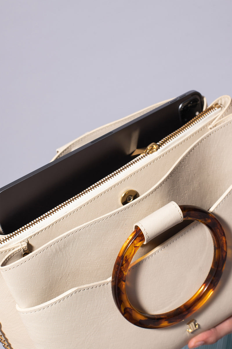 Womens leather shoulder bag with fur strap and plastic round handle in beige colour by JULKE