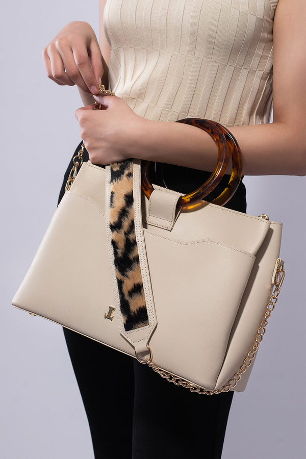 Womens leather shoulder bag with fur strap and plastic round handle in beige colour by JULKE